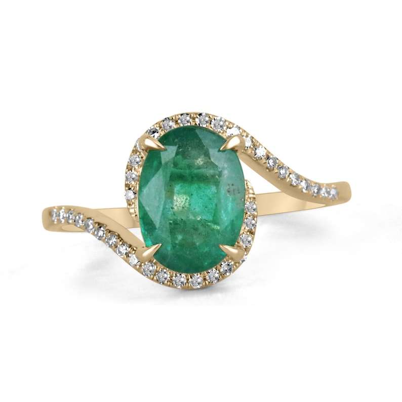 1.80tw 14K yellow gold oval emerald and diamond accent ladies ring with twisted shank.