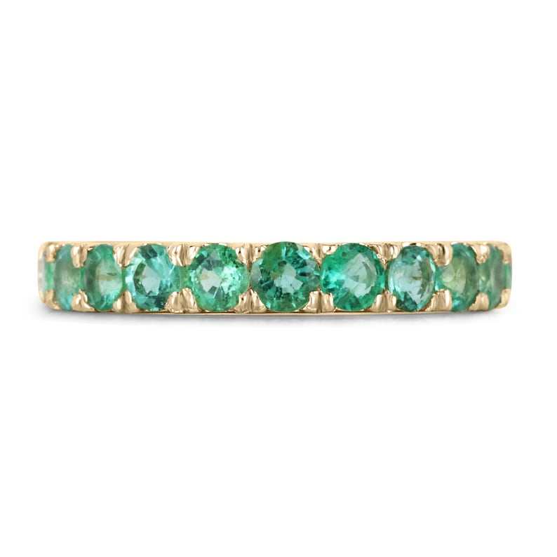 14K gold band ring with vivid medium green round cut natural emeralds in a French-set style
