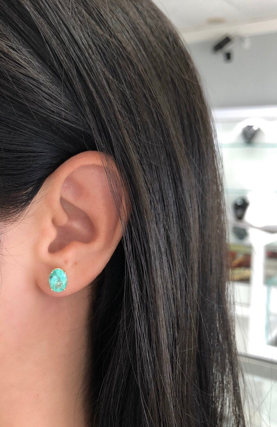 3.30 carat Colombian Oval Emerald Stud classic stud earrings in solid gold on ear 