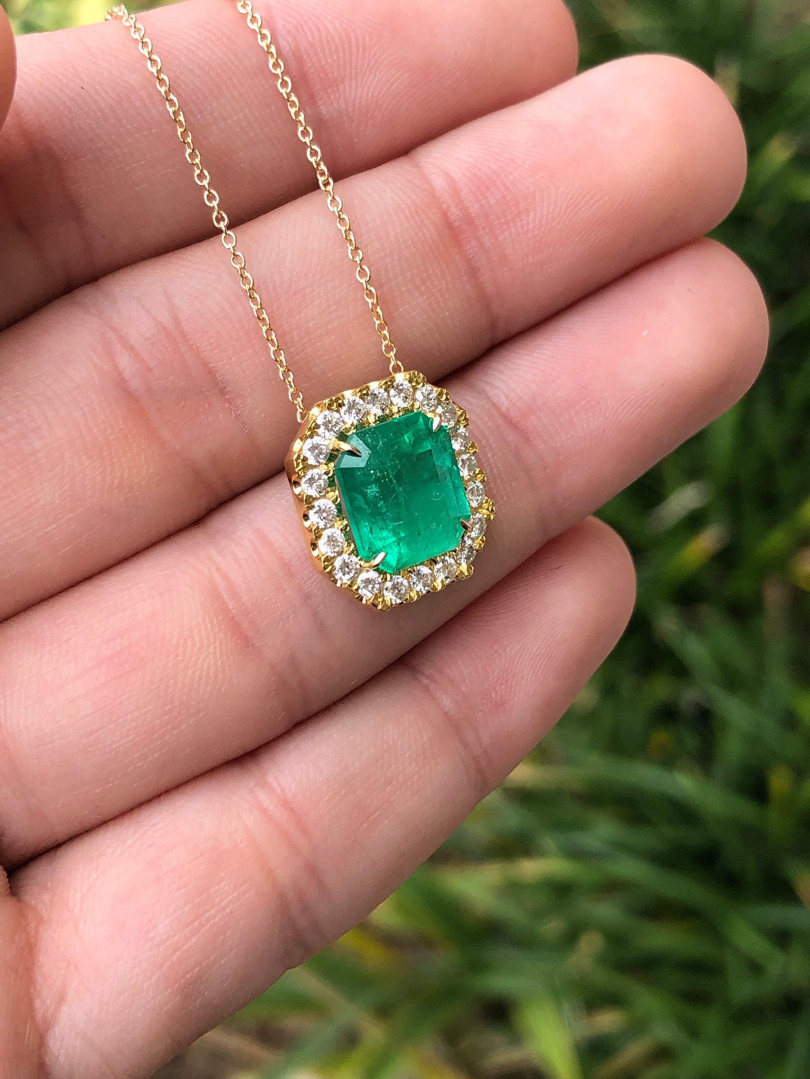 Square cut Colombian emerald and diamond halo necklace pendant in 14k yellow gold, featuring a 4.60 tcw natural emerald.