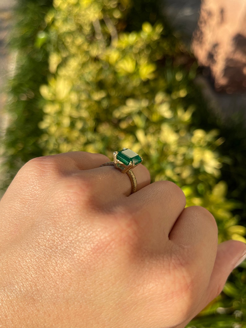 Colombian Emerald 4.45ct 18K matte hammered gold double claw prong solitaire ring with dark green emerald cut gemstone