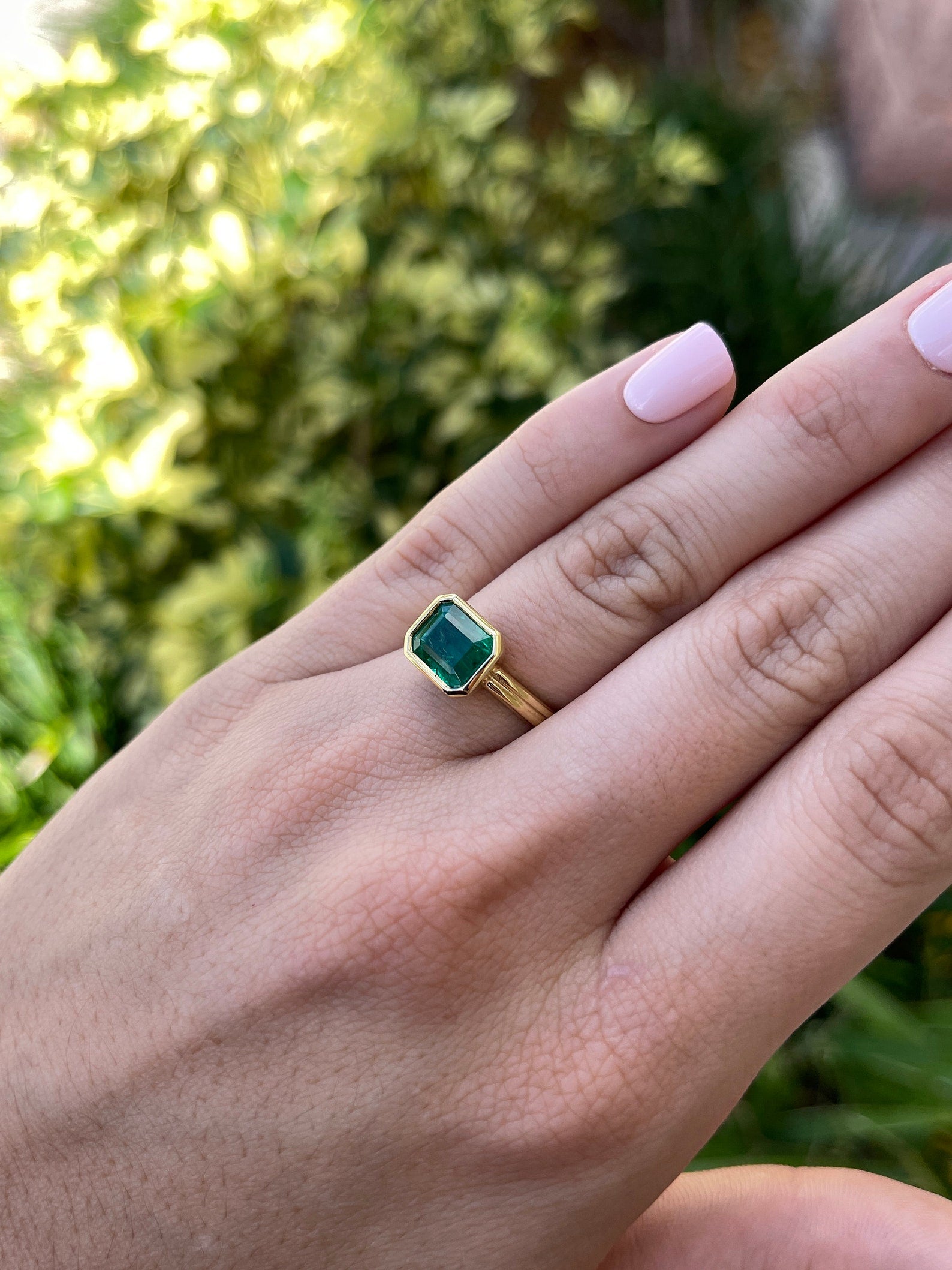 Natural dark vivid green emerald bezel solitaire ring featuring 2.75ct east-to-west cut, set in 18K gold by JR Colombian Emeralds.