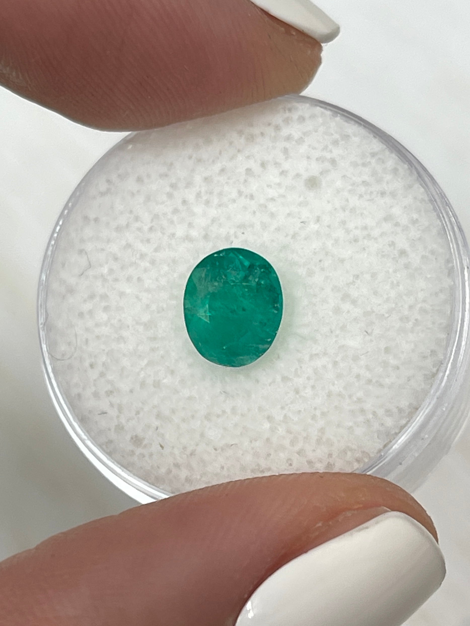 Semi-transparent 1.19 carat oval cut Colombian emerald from JR Colombian Emeralds showcasing rich green natural color.