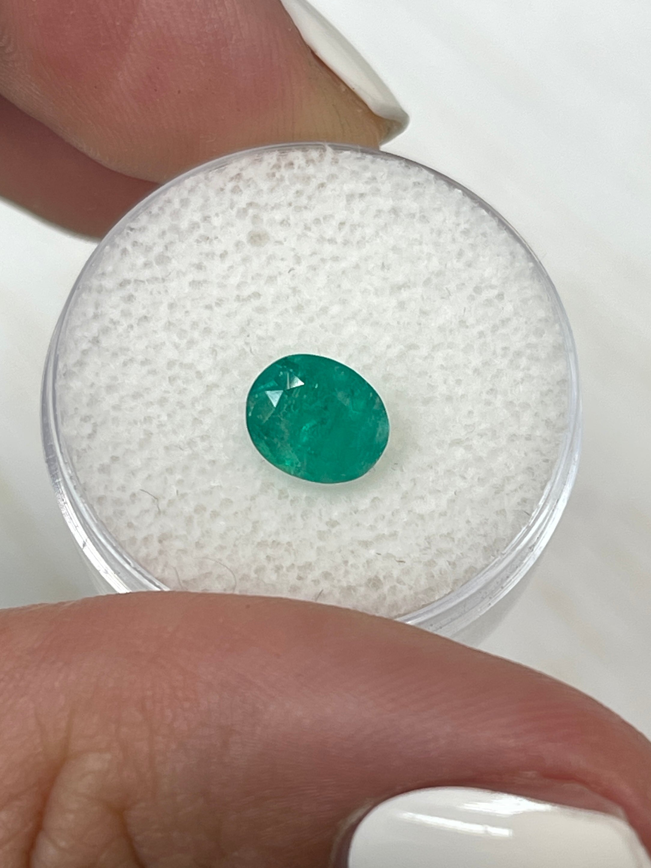 Oval cut 1.19 carat semi-transparent rich green natural Colombian emerald from JR Colombian Emeralds.