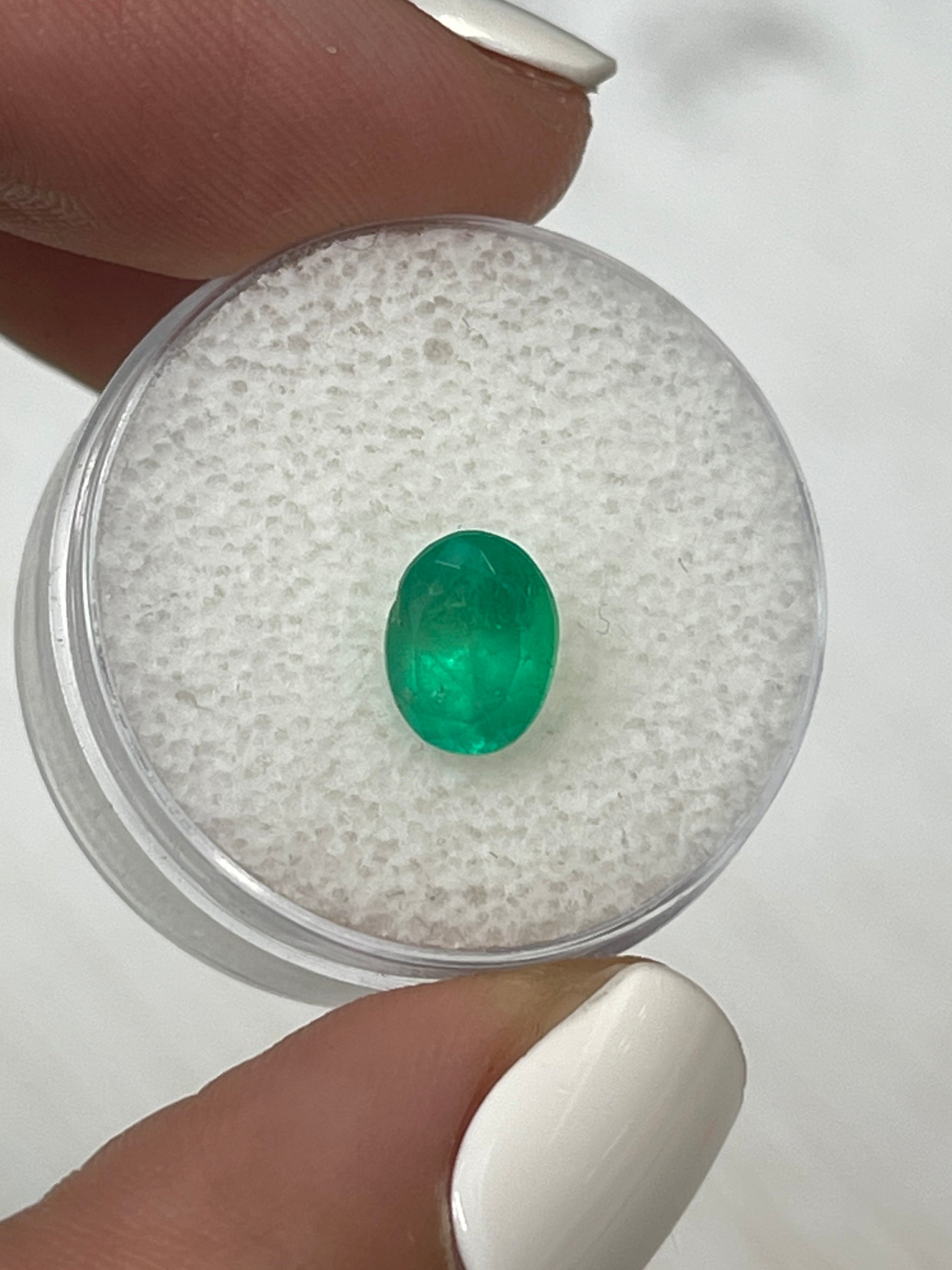 Bright apple green 1.40 carat natural Colombian emerald in oval cut, from JR Colombian Emeralds, loose gemstone.