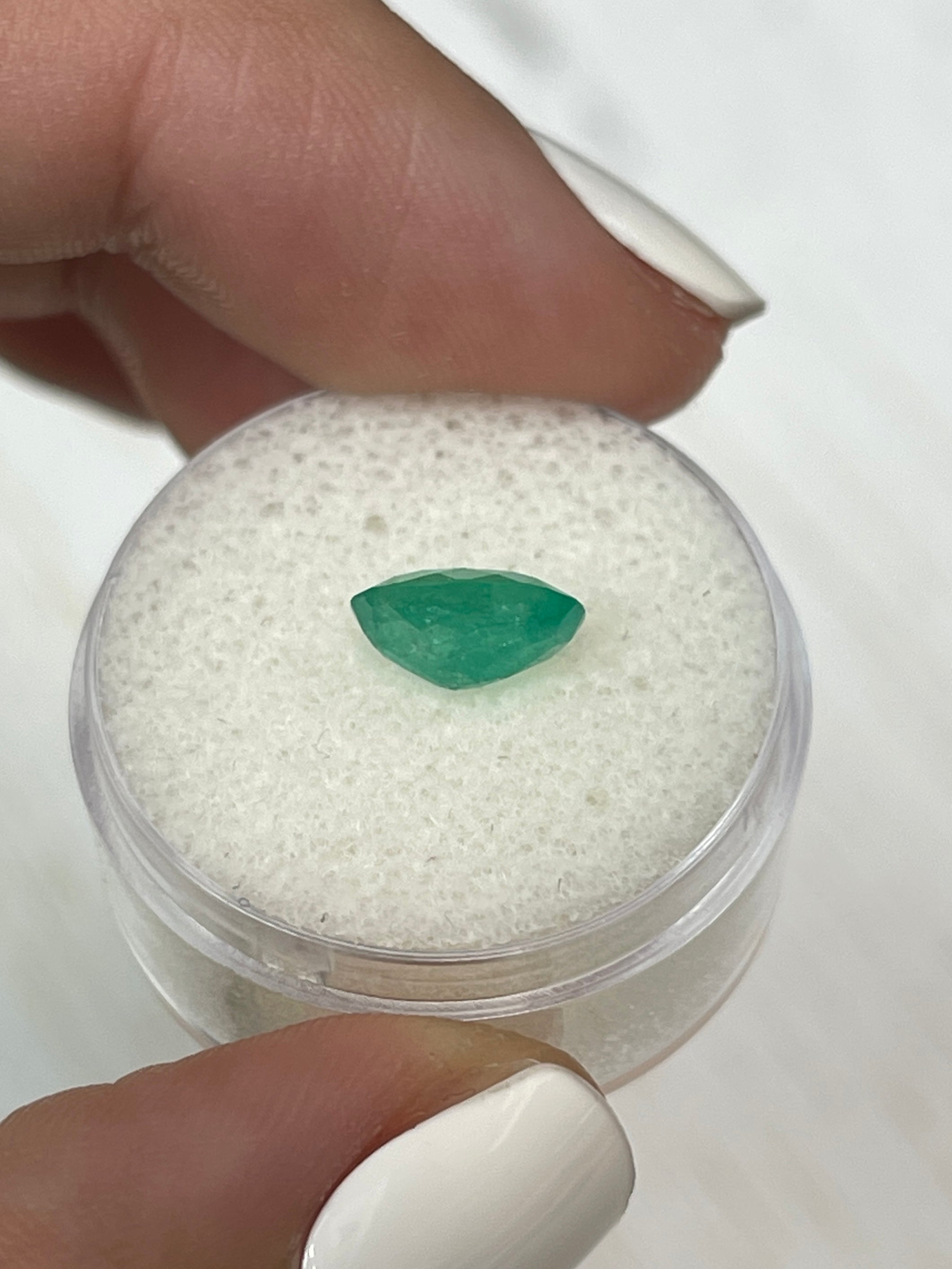 Loose 1.63 carat bluish green Colombian emerald in oval cut, natural, cloudy appearance, from JR Colombian Emeralds.