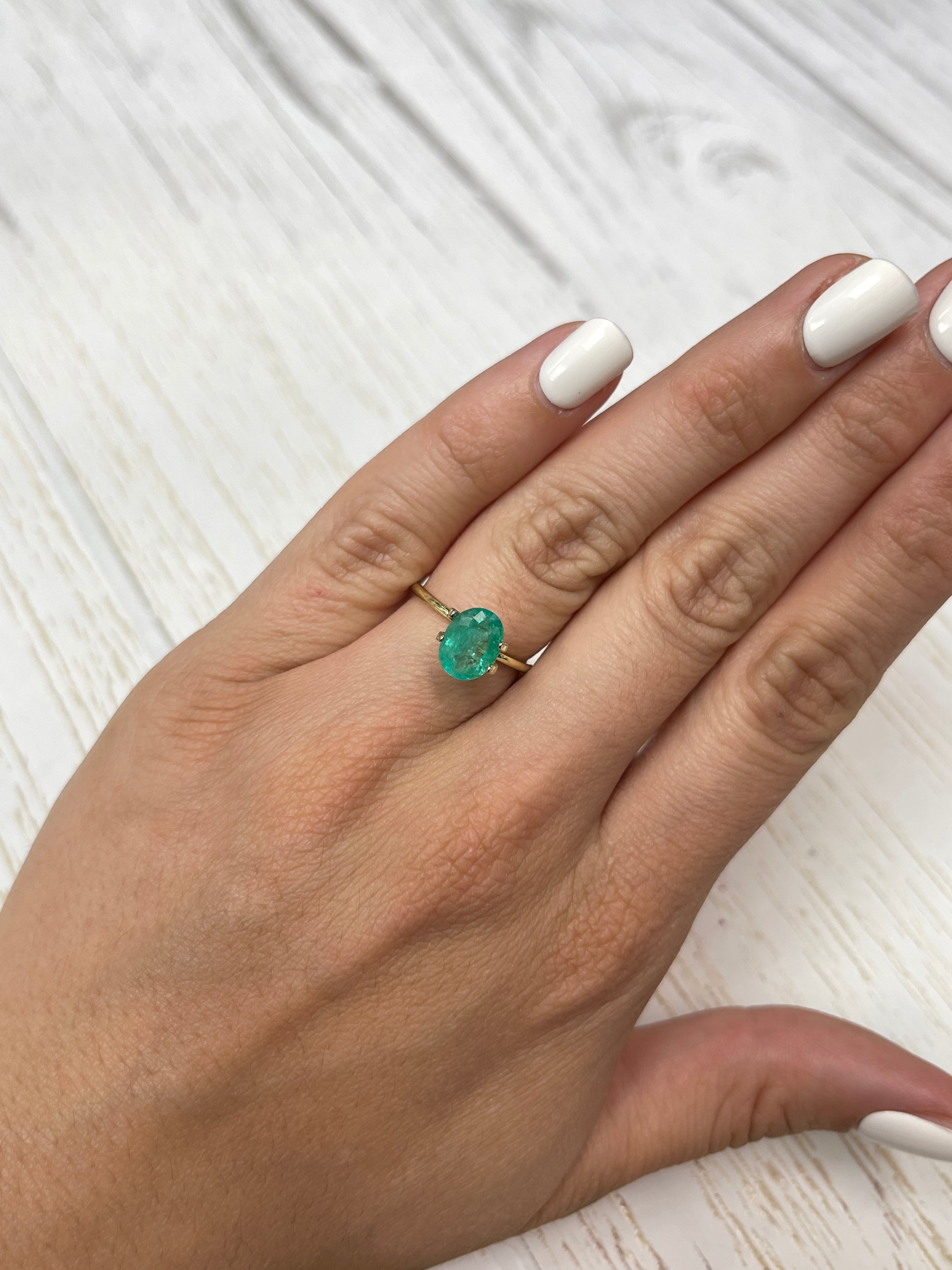 Oval cut 1.63 carat bluish green natural Colombian emerald gemstone with cloudy appearance, sourced from JR Colombian Emeralds.