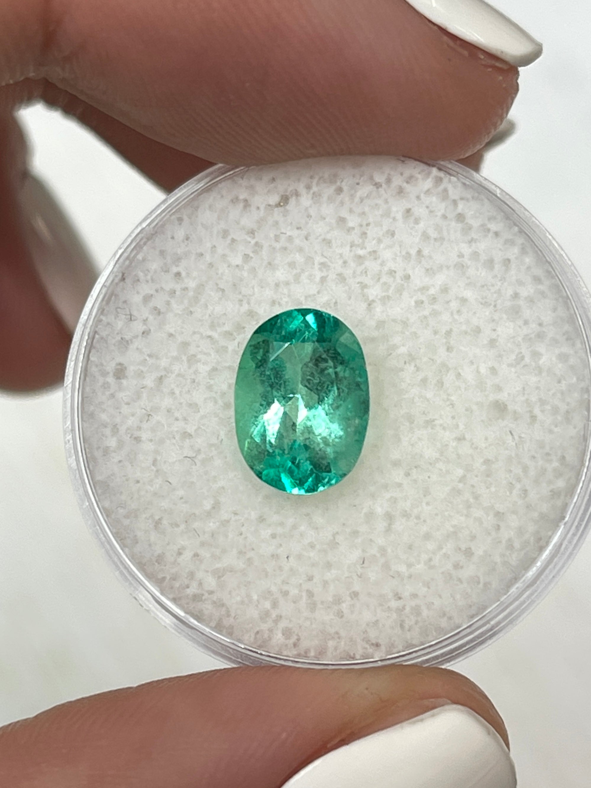 Oval cut 1.77 carat medium-light green Colombian emerald loose gemstone from JR Colombian Emeralds.