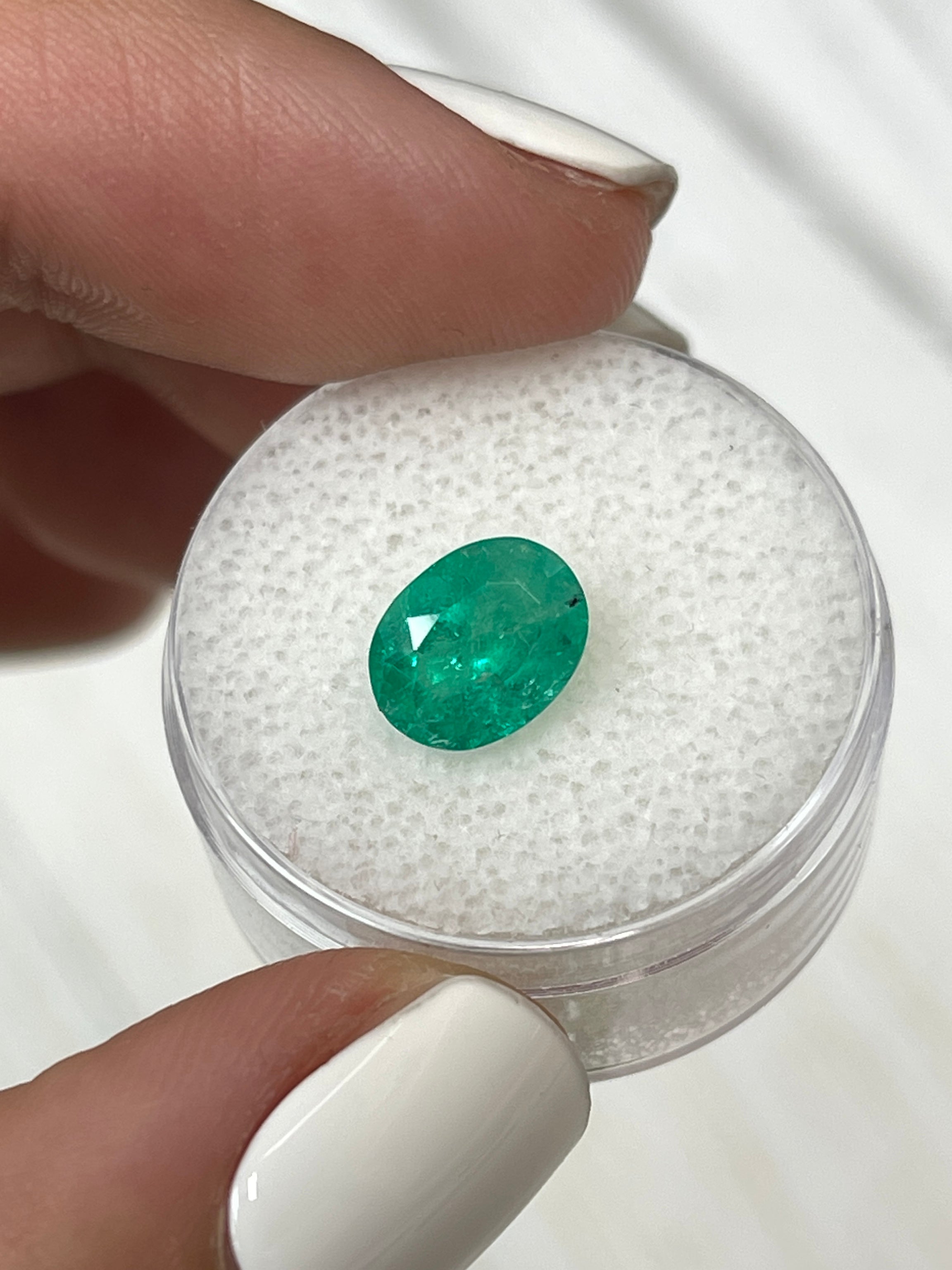 Oval cut 1.87 carat medium green natural Colombian emerald gemstone from JR Colombian Emeralds.