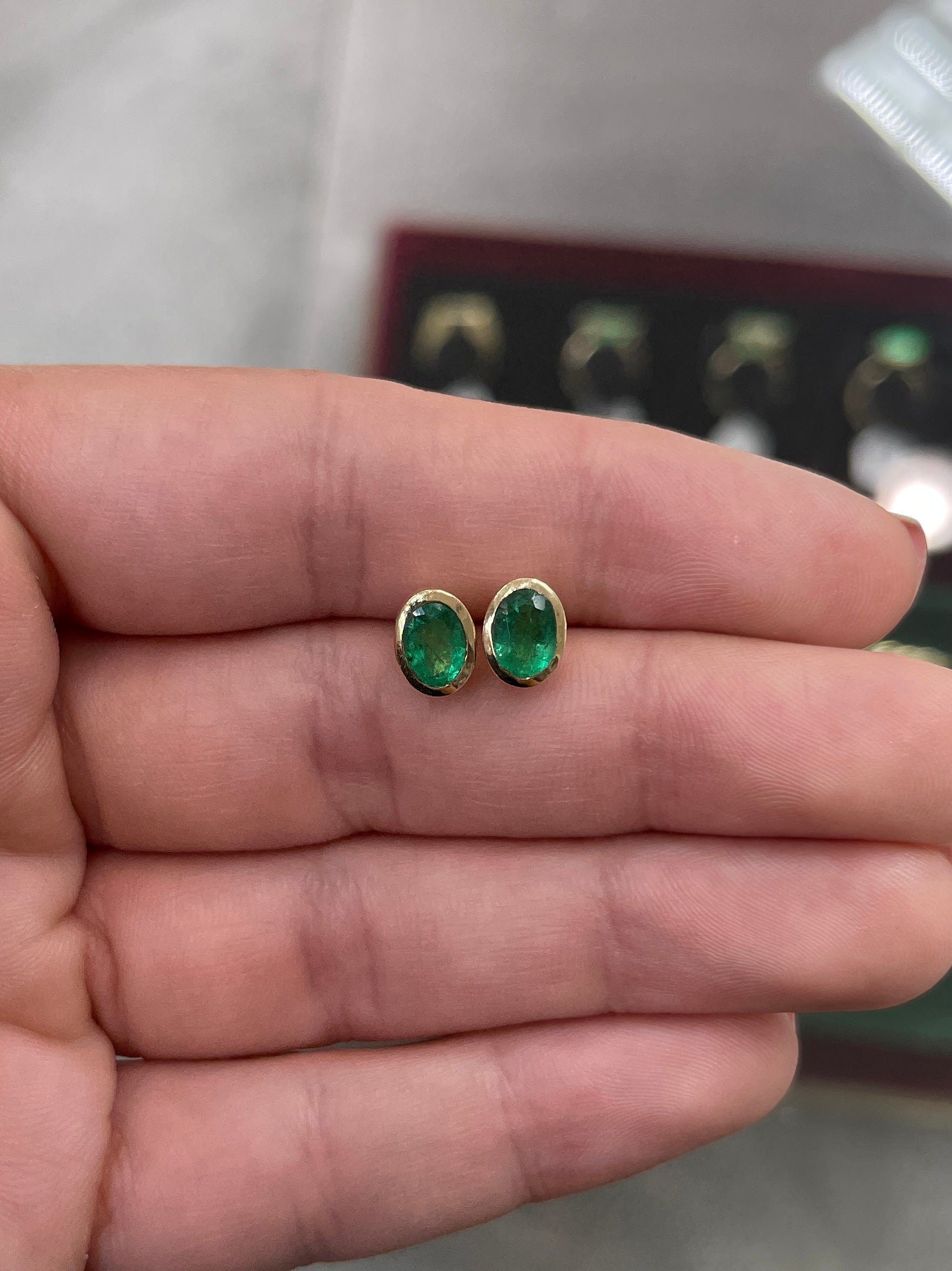 14K gold emerald stud earrings with oval-cut natural emeralds, bezel setting, 1.87 carats total weight, by JR Colombian Emeralds.