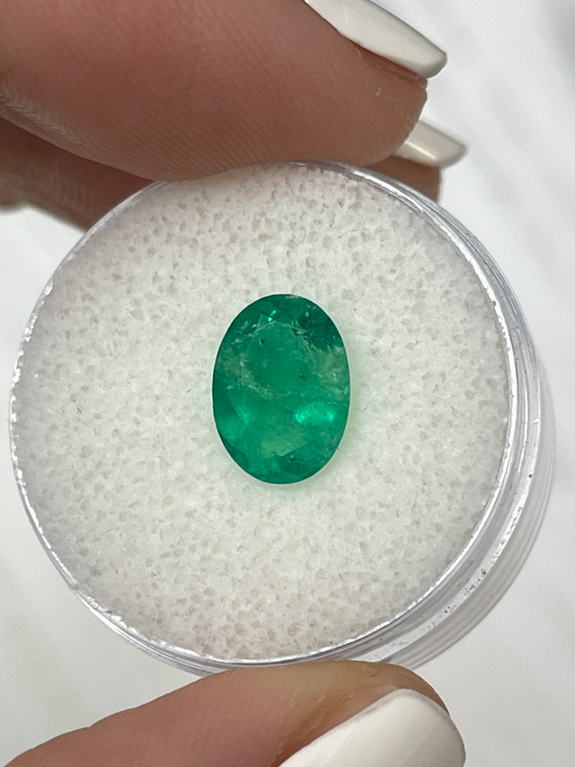 Loose 1.94 carat green Colombian emerald in oval cut, natural and unmounted, from JR Colombian Emeralds.