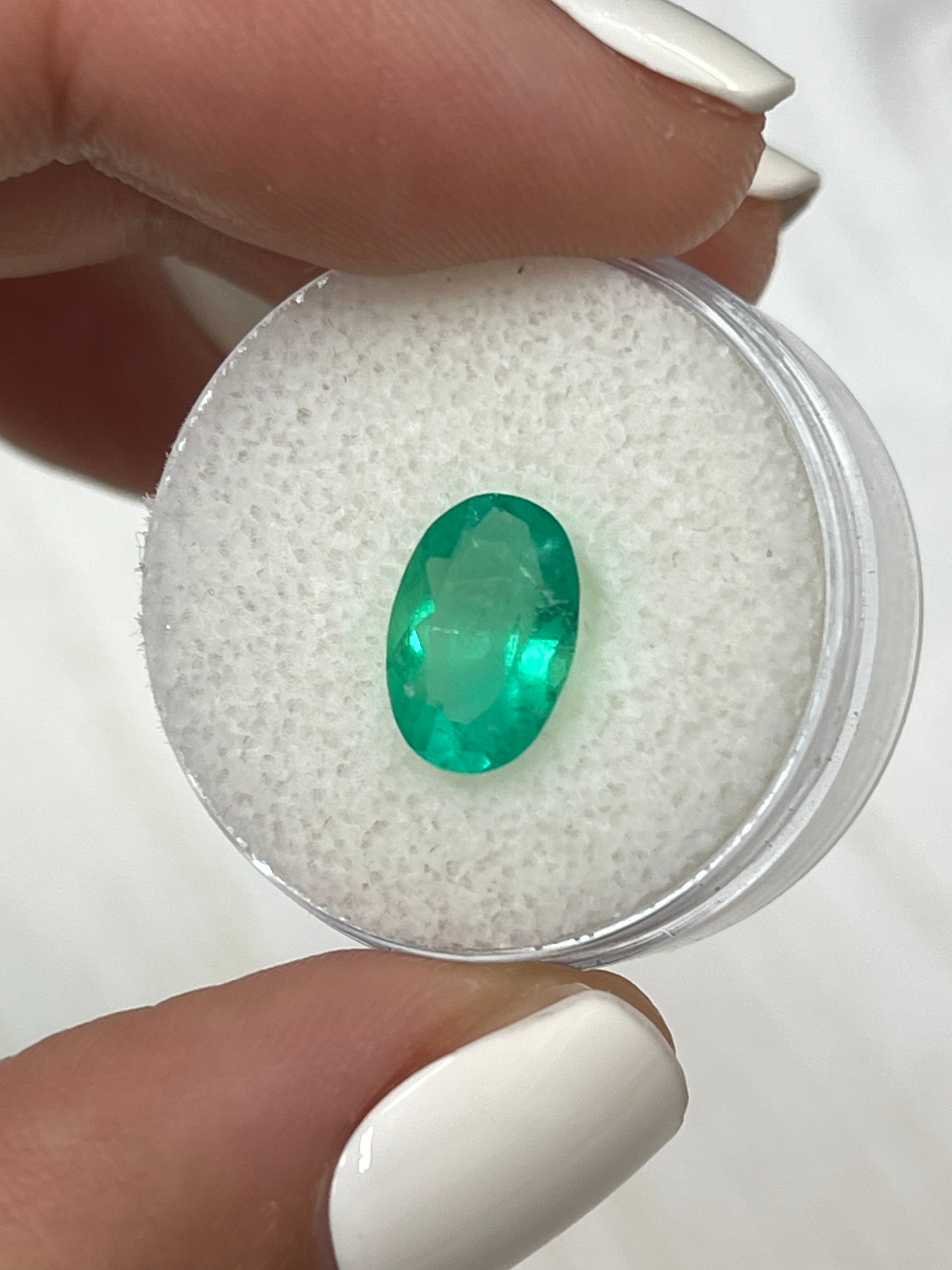 Elongated 11x8 mm Colombian emerald in apple green, oval cut, loose gemstone from JR Colombian Emeralds, 1.96 carats.