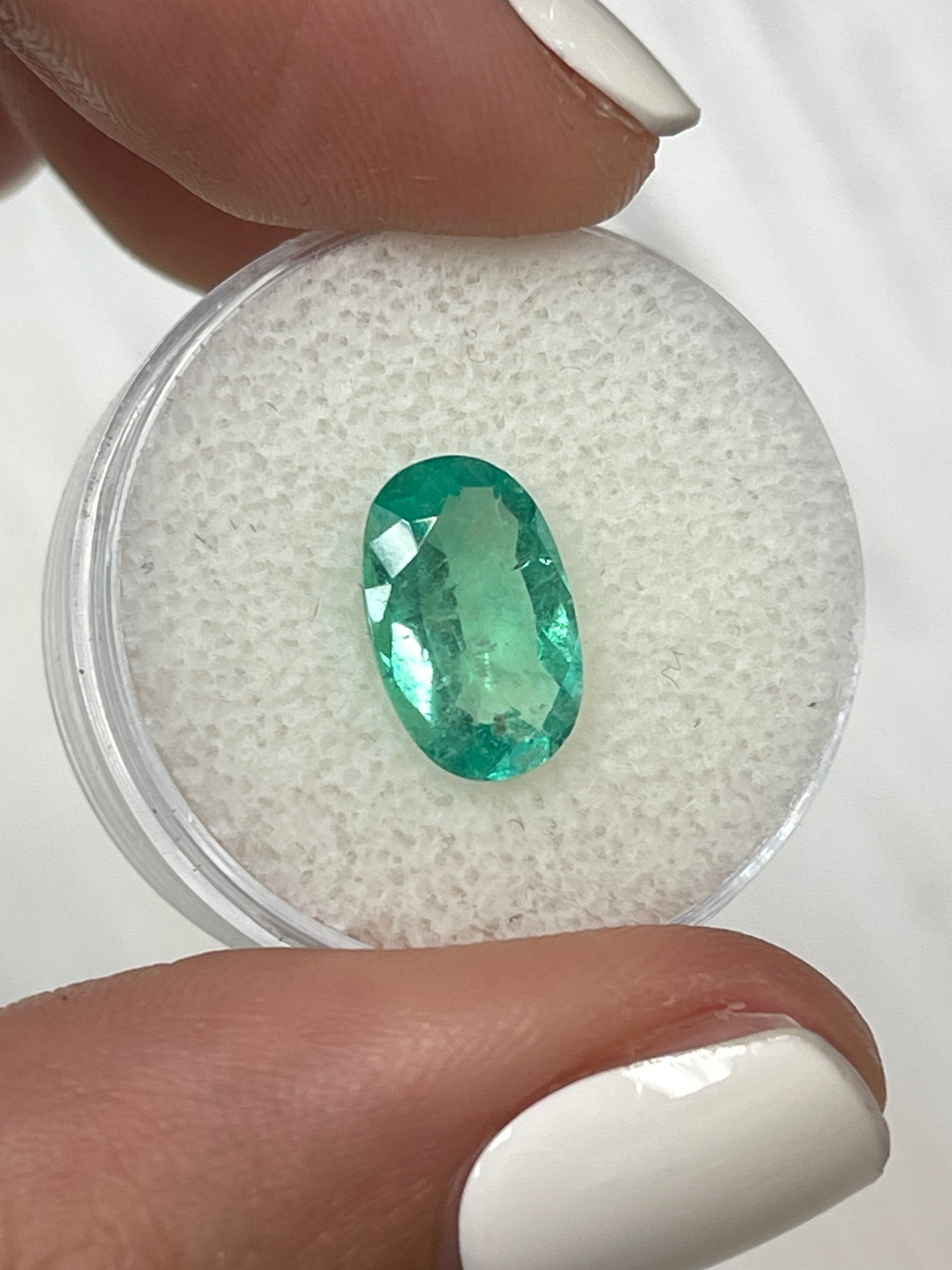 2.31 carat natural green Colombian emerald loose oval cut gemstone from JR Colombian Emeralds, elongated 12x7.5 mm shape.