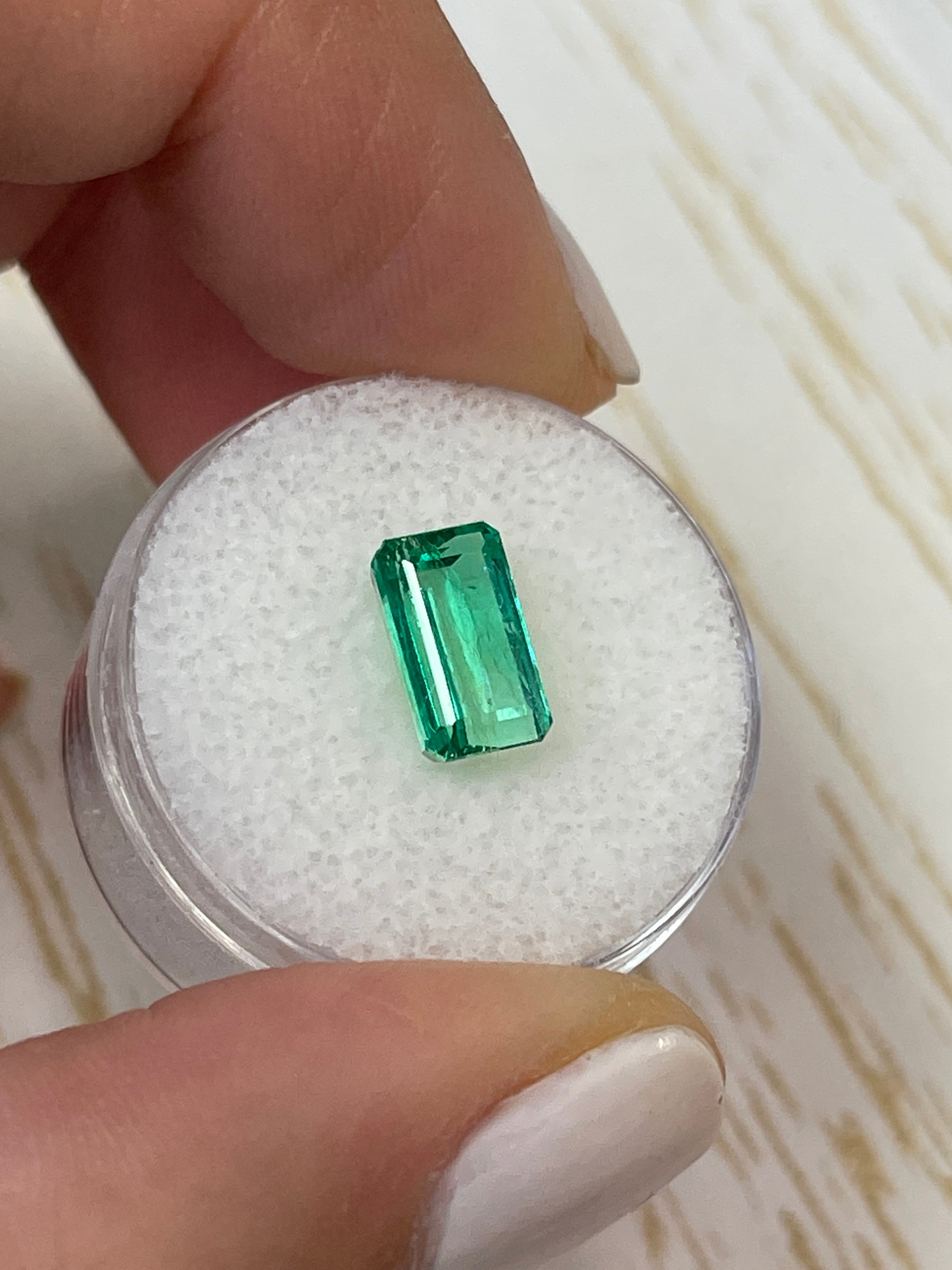2.38 carat slender emerald-cut Muzo green Colombian emerald loose gemstone from JR Colombian Emeralds.