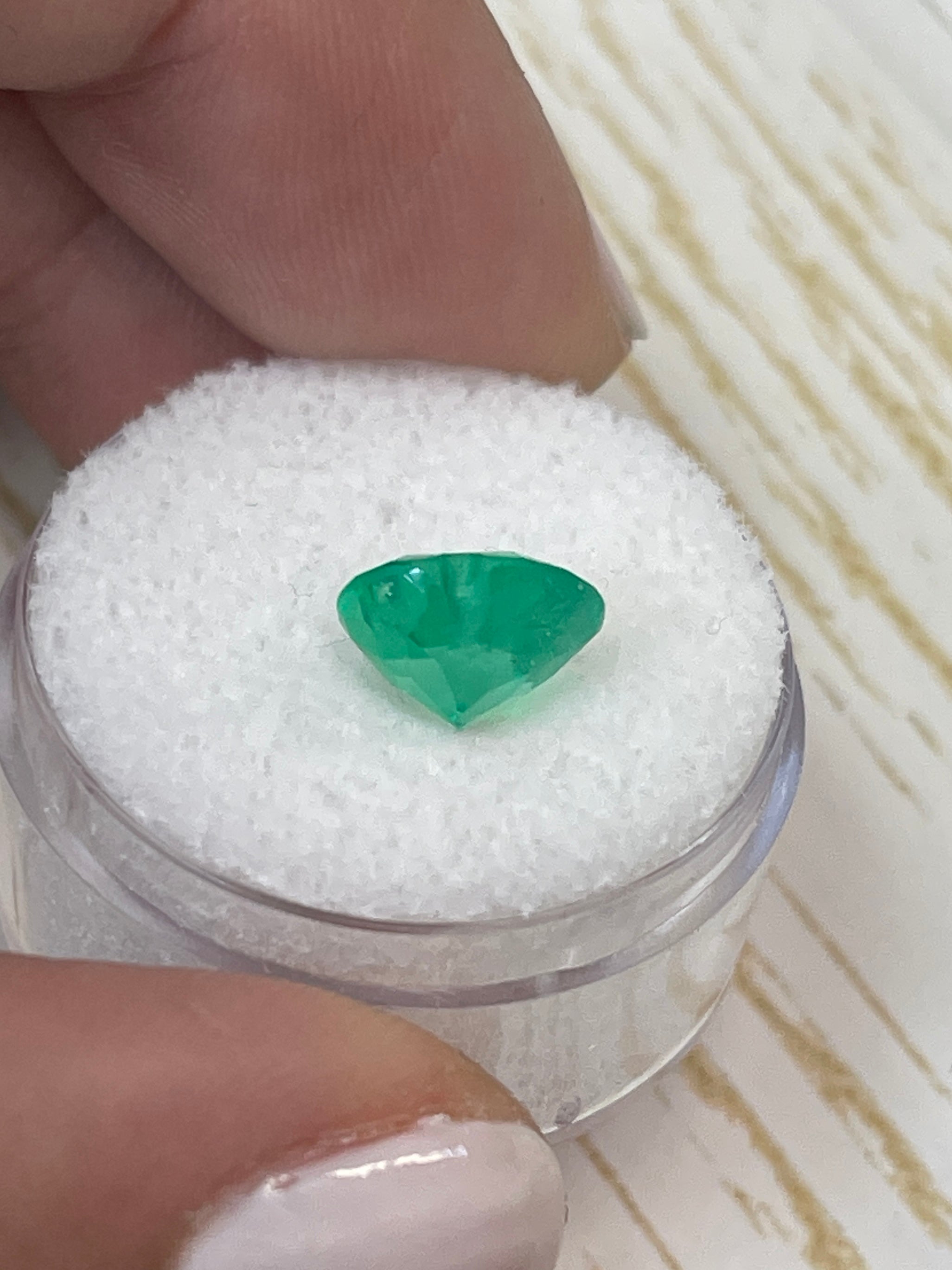 Natural 2.45 carat yellowish green Colombian emerald loose heart cut gemstone with vibrant color and clarity.