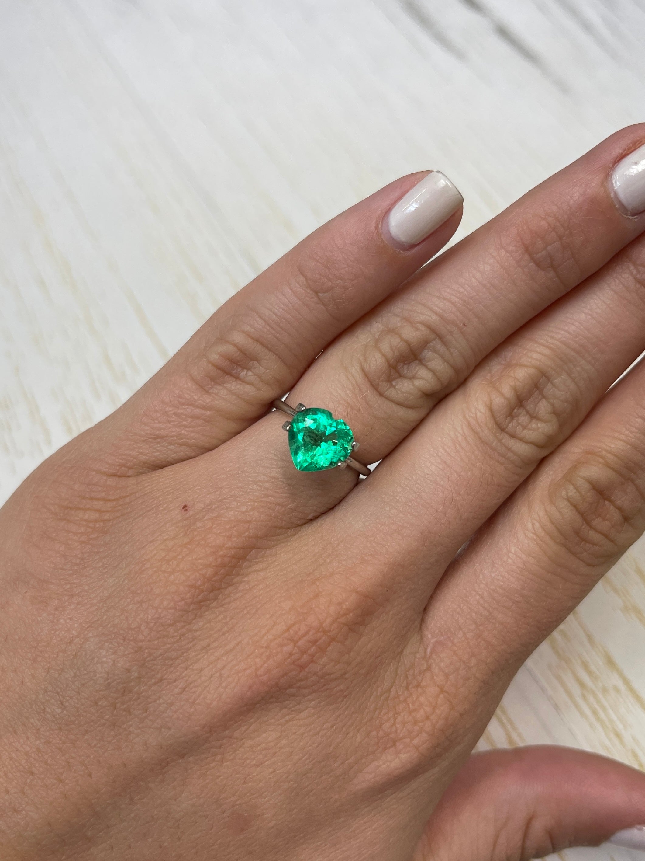 Natural 2.45 carat yellowish-green Colombian emerald in heart cut, showcasing vibrant color and clarity, loose gemstone from JR Colombian Emeralds.