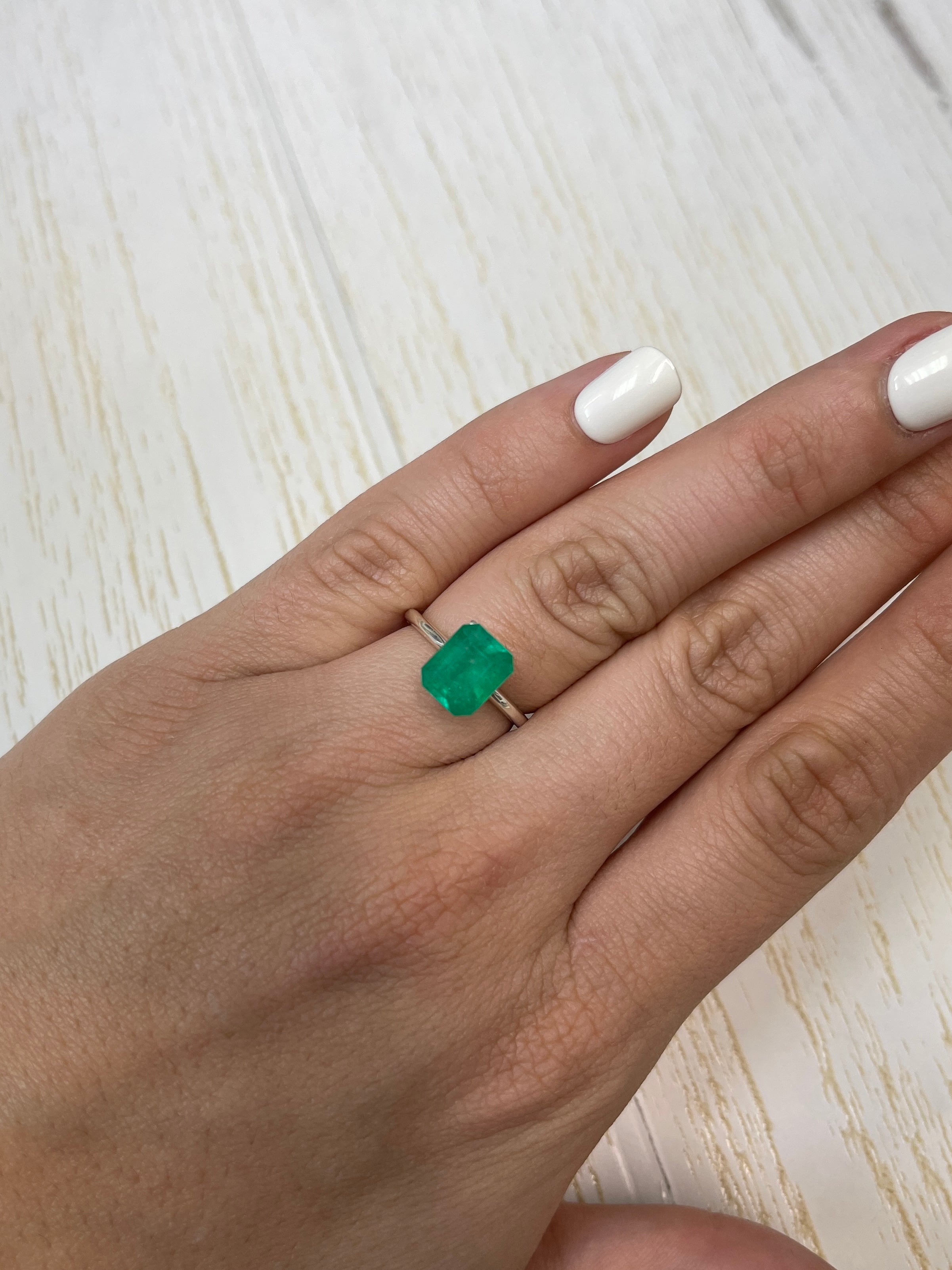2.52 carat intense green natural Colombian emerald loose gemstone in an emerald cut, showcasing vibrant color and clarity.