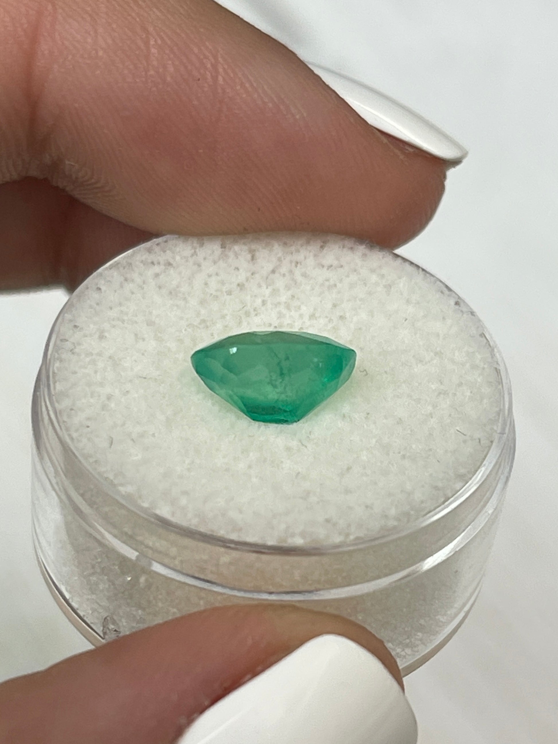 2.53 carat natural green Colombian emerald loose oval cut gemstone from JR Colombian Emeralds on display.