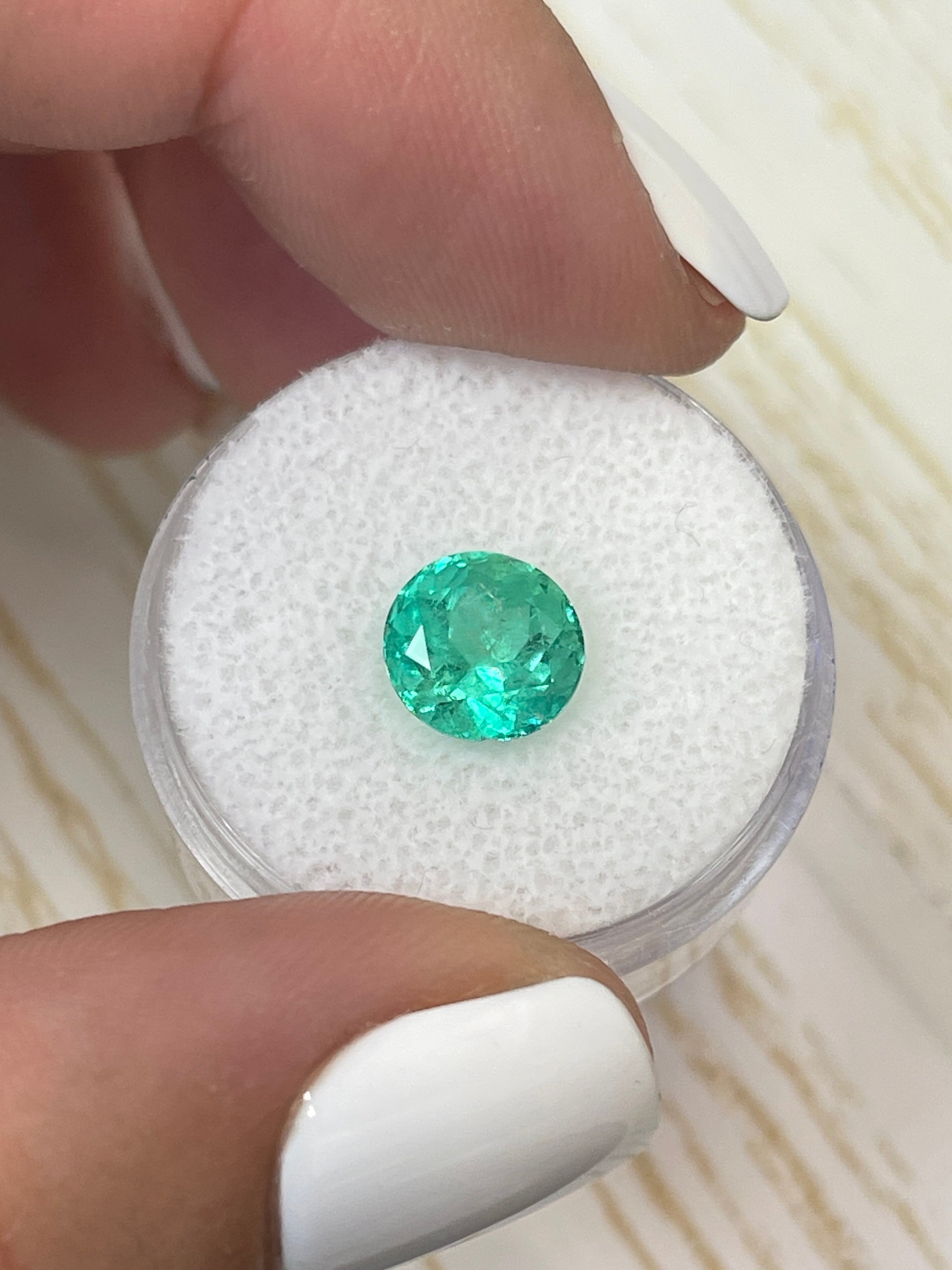 Round 2.56 carat medium green natural Colombian emerald gemstone, loose and polished, showcasing vibrant color and clarity.
