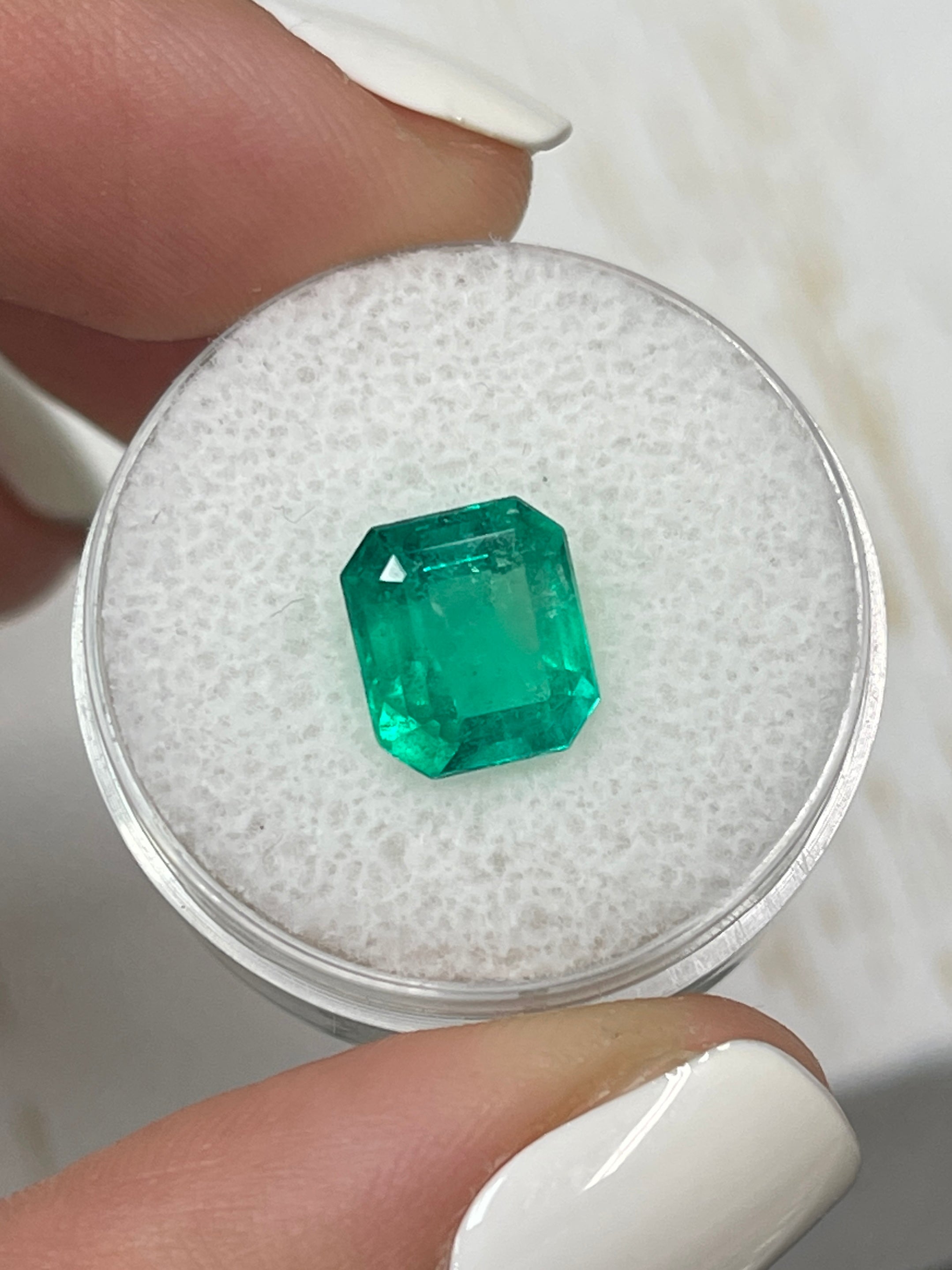 2.63 Carat deep bluish natural Colombian emerald loose gemstone in an emerald cut, showcased by JR Colombian Emeralds.
