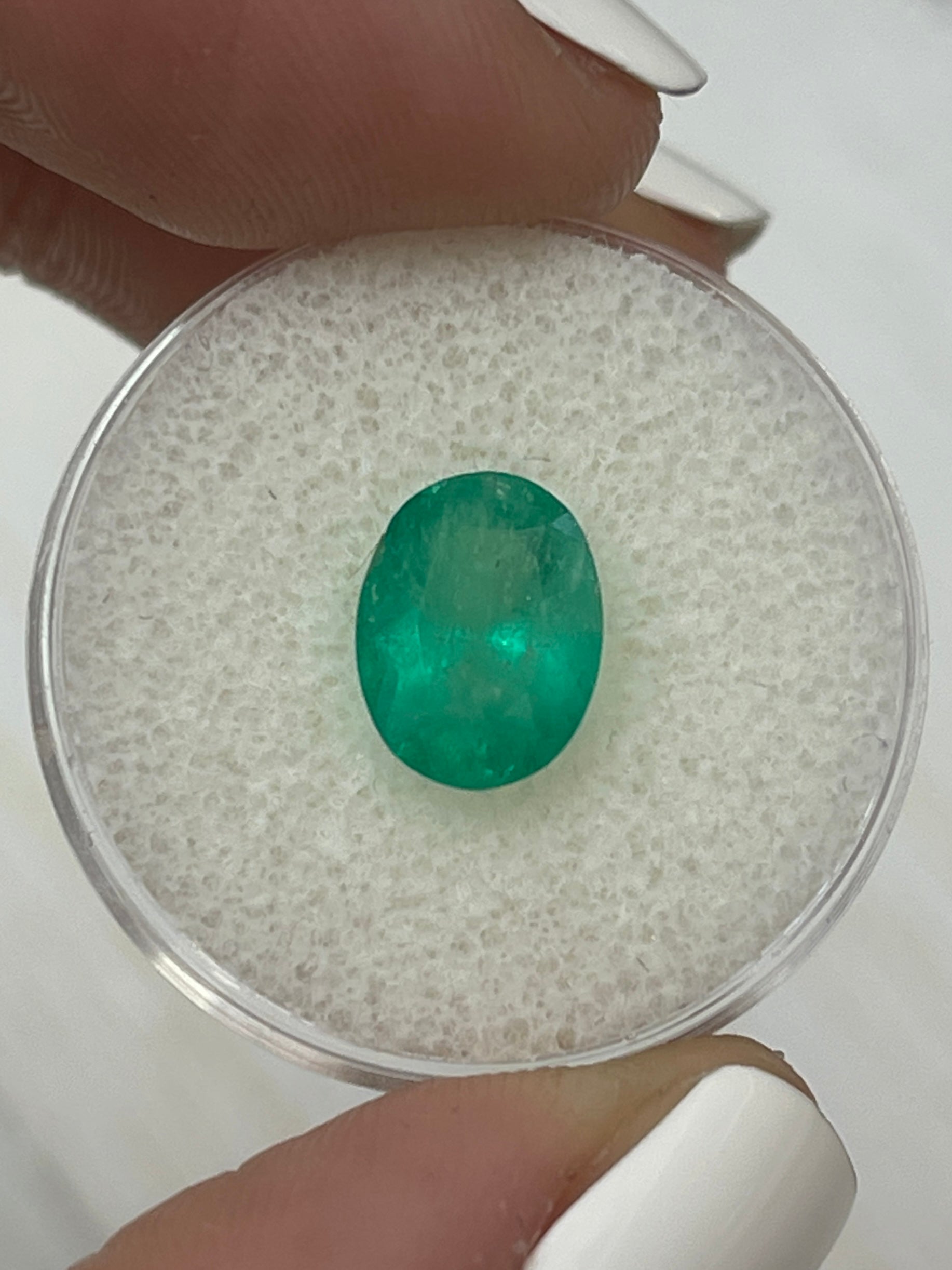 2.69 carat green natural Colombian emerald loose oval cut gemstone by JR Colombian Emeralds, showcasing vibrant green color and clarity.
