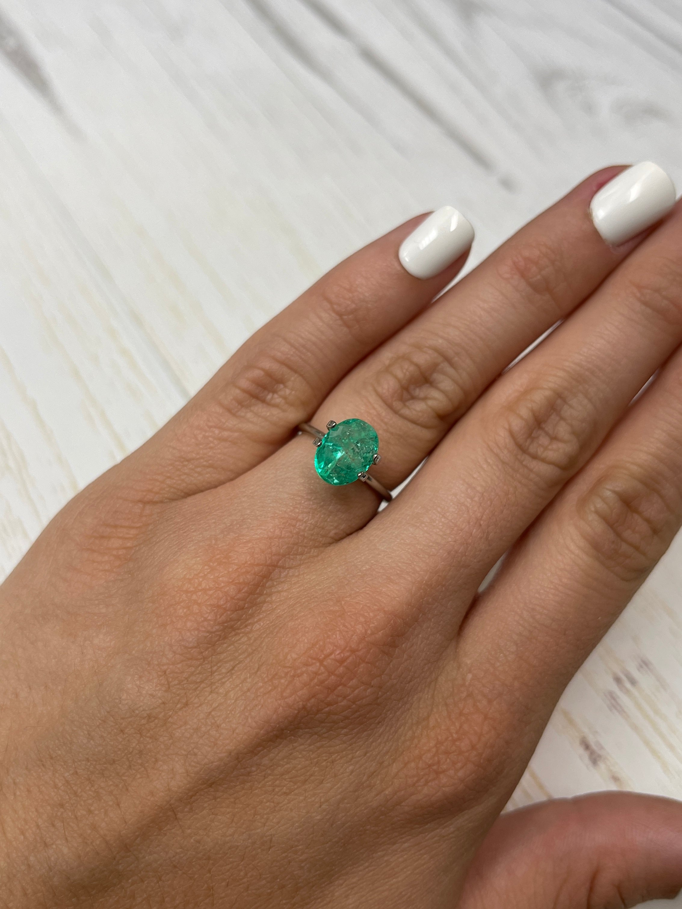 2.75 carat lightly freckled green Colombian emerald in oval cut, loose gemstone from JR Colombian Emeralds.