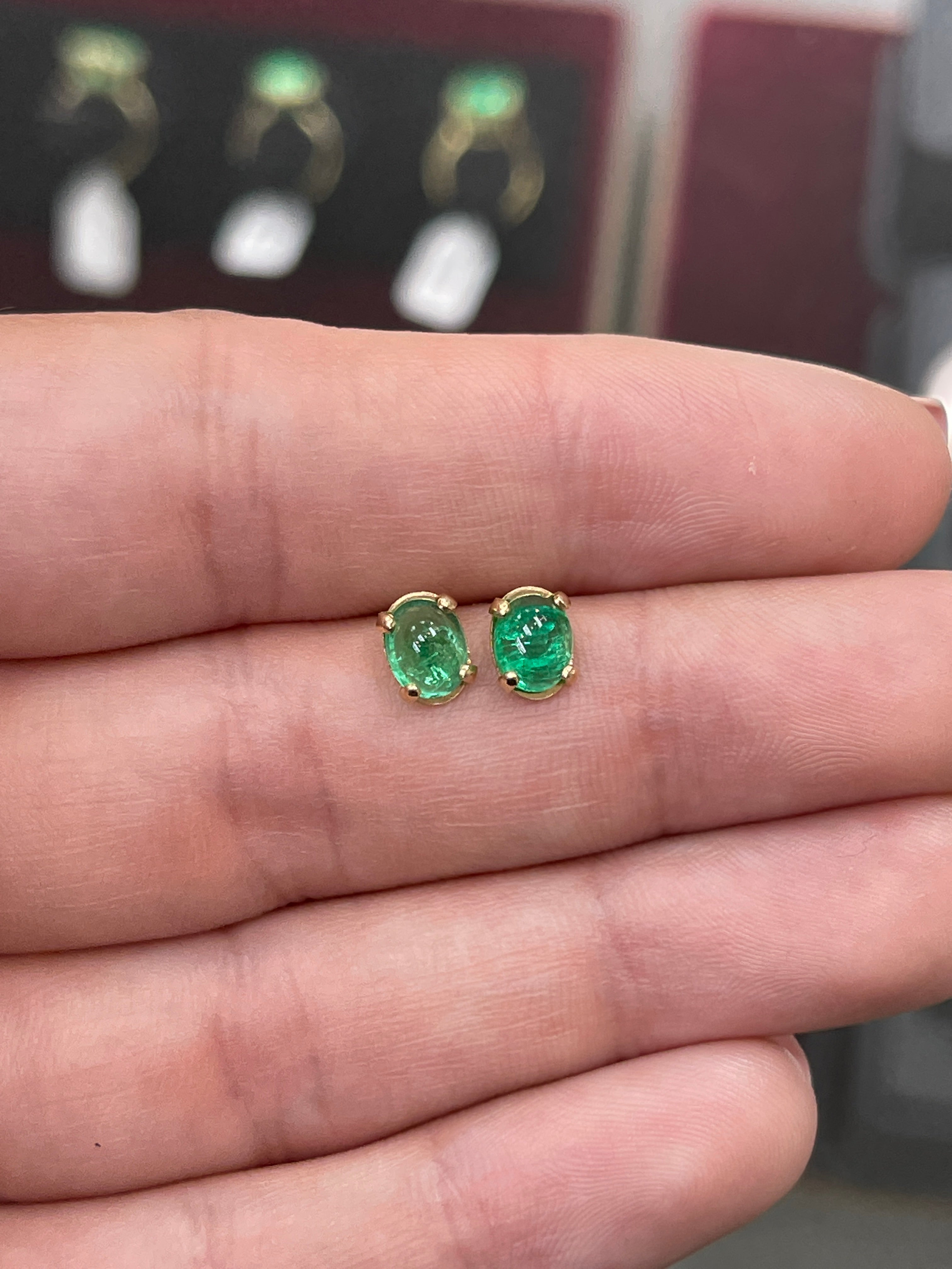 Deep green emerald oval cabochon stud earrings in 14K gold showcased by JR Colombian Emeralds, featuring a 2.78 carat total weight.