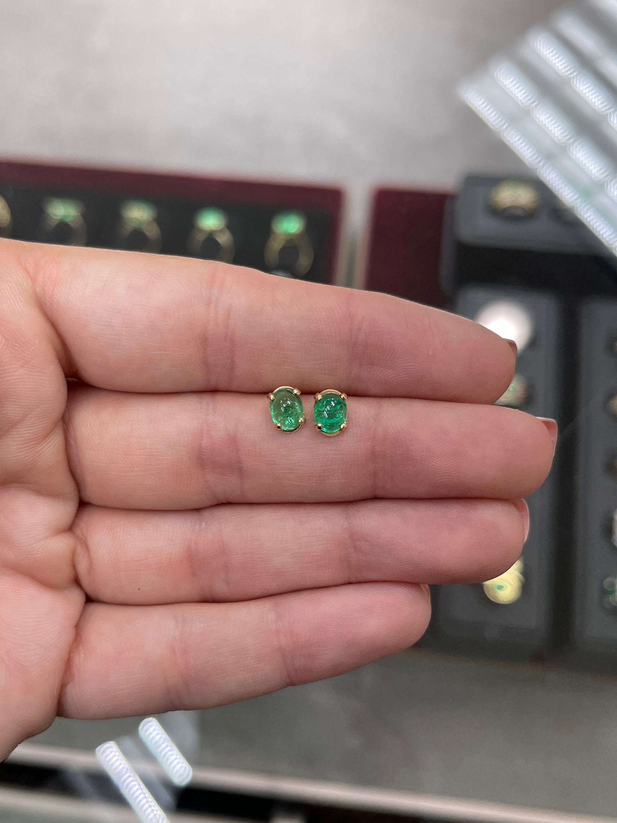 Deep green emerald oval cabochon solitaire stud earrings in 14K gold by JR Colombian Emeralds, showcased on a white background.