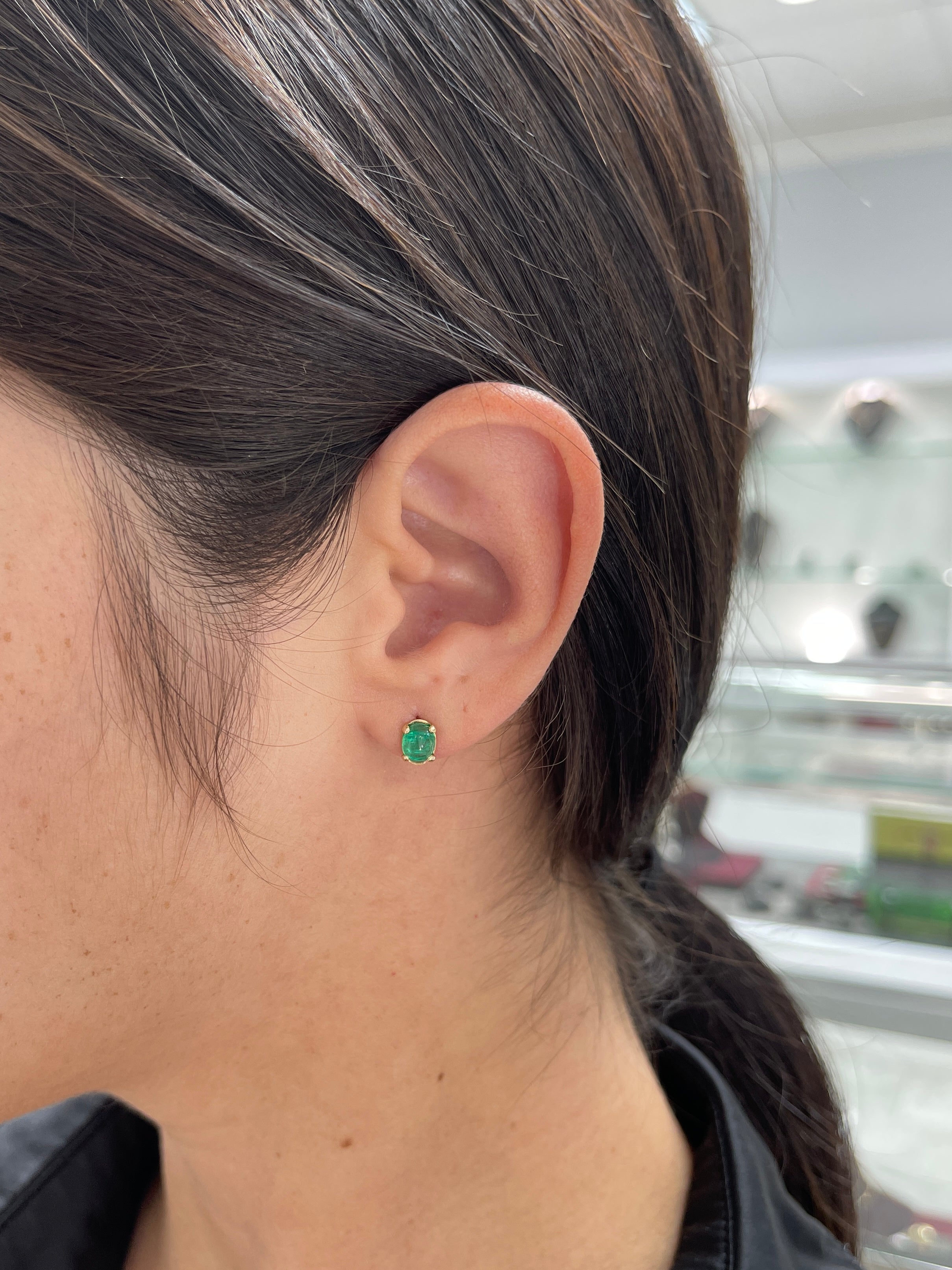Deep green emerald oval cabochon solitaire stud earrings in 14K gold by JR Colombian Emeralds, showcasing elegant gemstone craftsmanship.