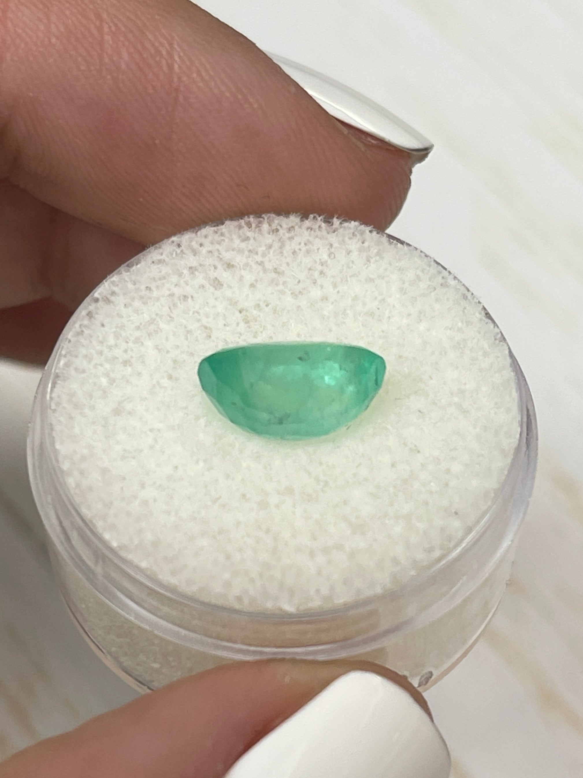 2.83 Carat oval cut pastel mint green Colombian emerald loose gemstone by JR Colombian Emeralds on a white background.