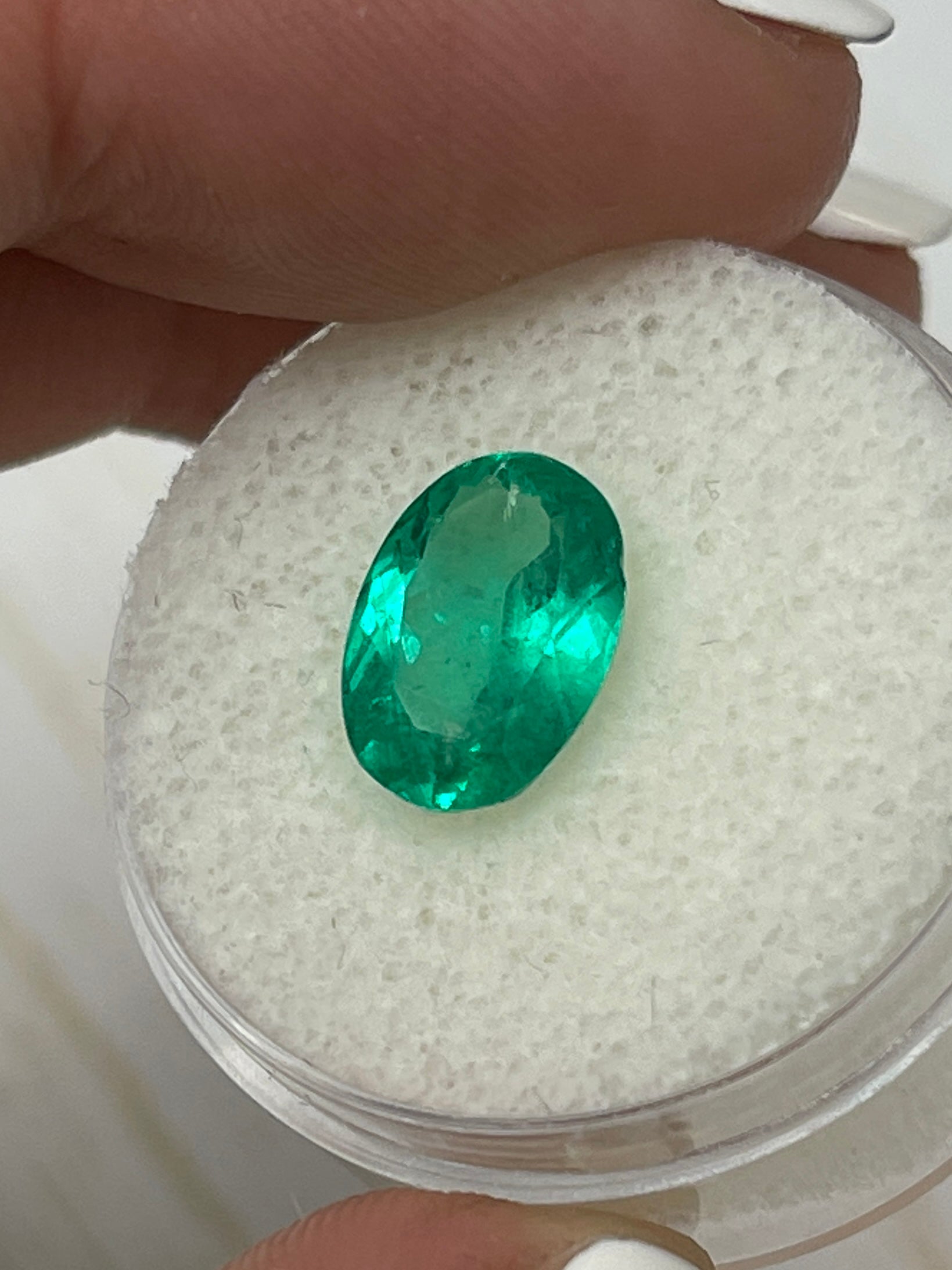 Vibrant green 2.87 carat Colombian emerald loose oval cut gemstone from JR Colombian Emeralds, showcasing its elongated shape and rich color.