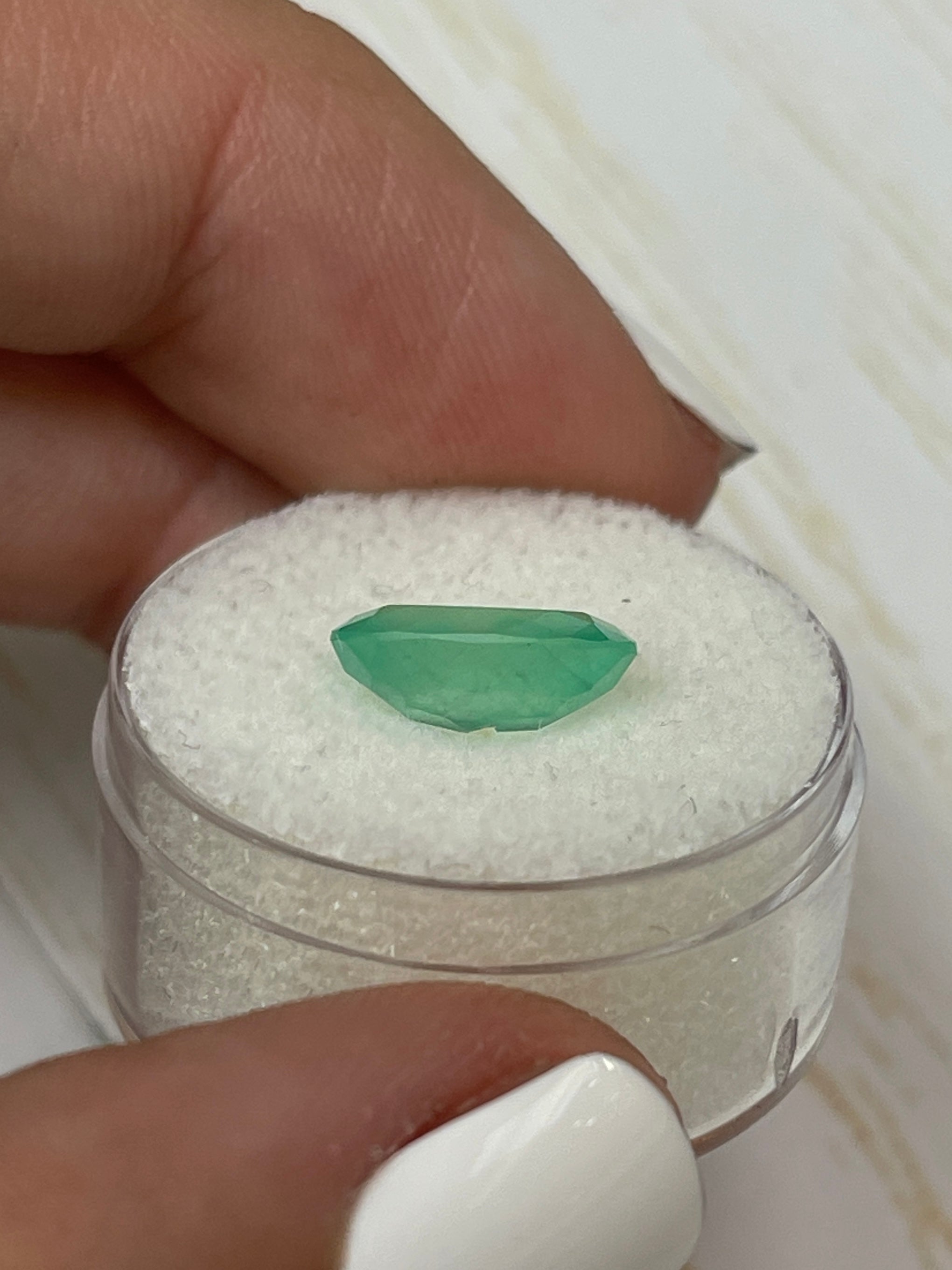 2.90 carat natural Colombian emerald loose oval cut in pastel mint green, showcasing vibrant color and clarity, by JR Colombian Emeralds.