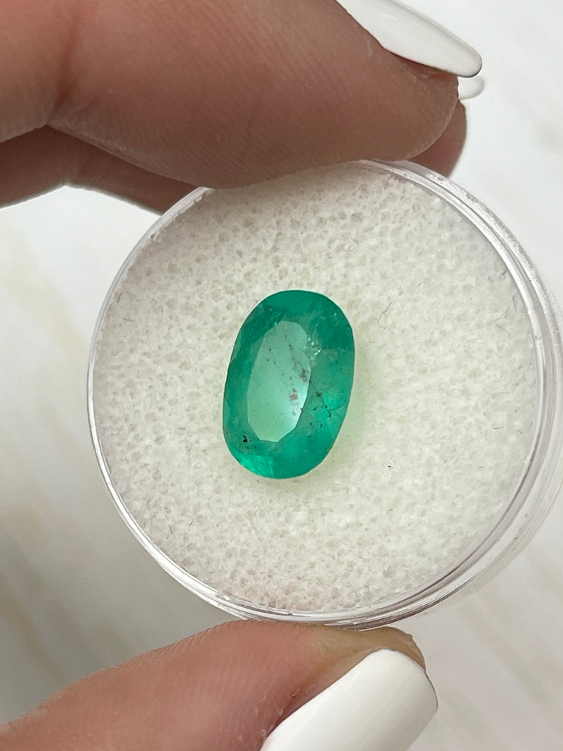 Medium green Colombian emerald loose gemstone, 2.95 carats, oval cut with natural freckled inclusions, from JR Colombian Emeralds.