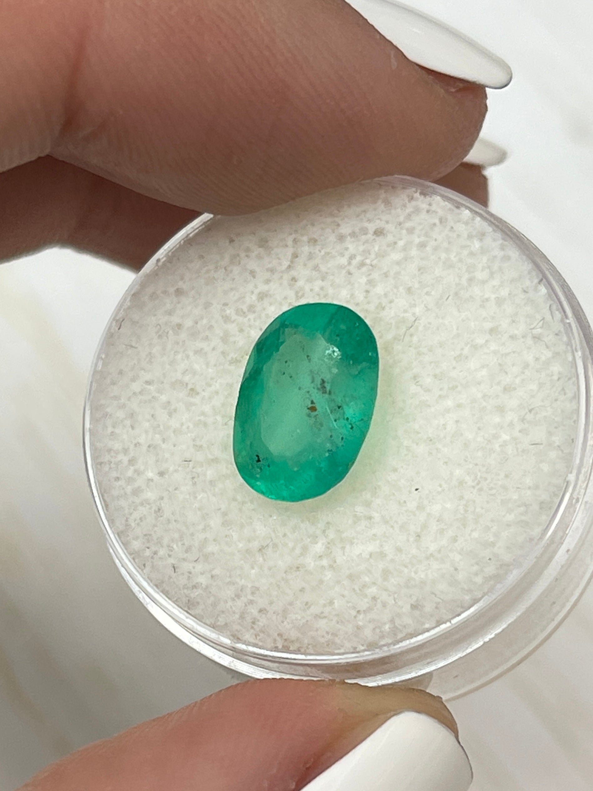 Medium green Colombian emerald loose oval cut, 2.95 carats with natural freckles, from JR Colombian Emeralds.