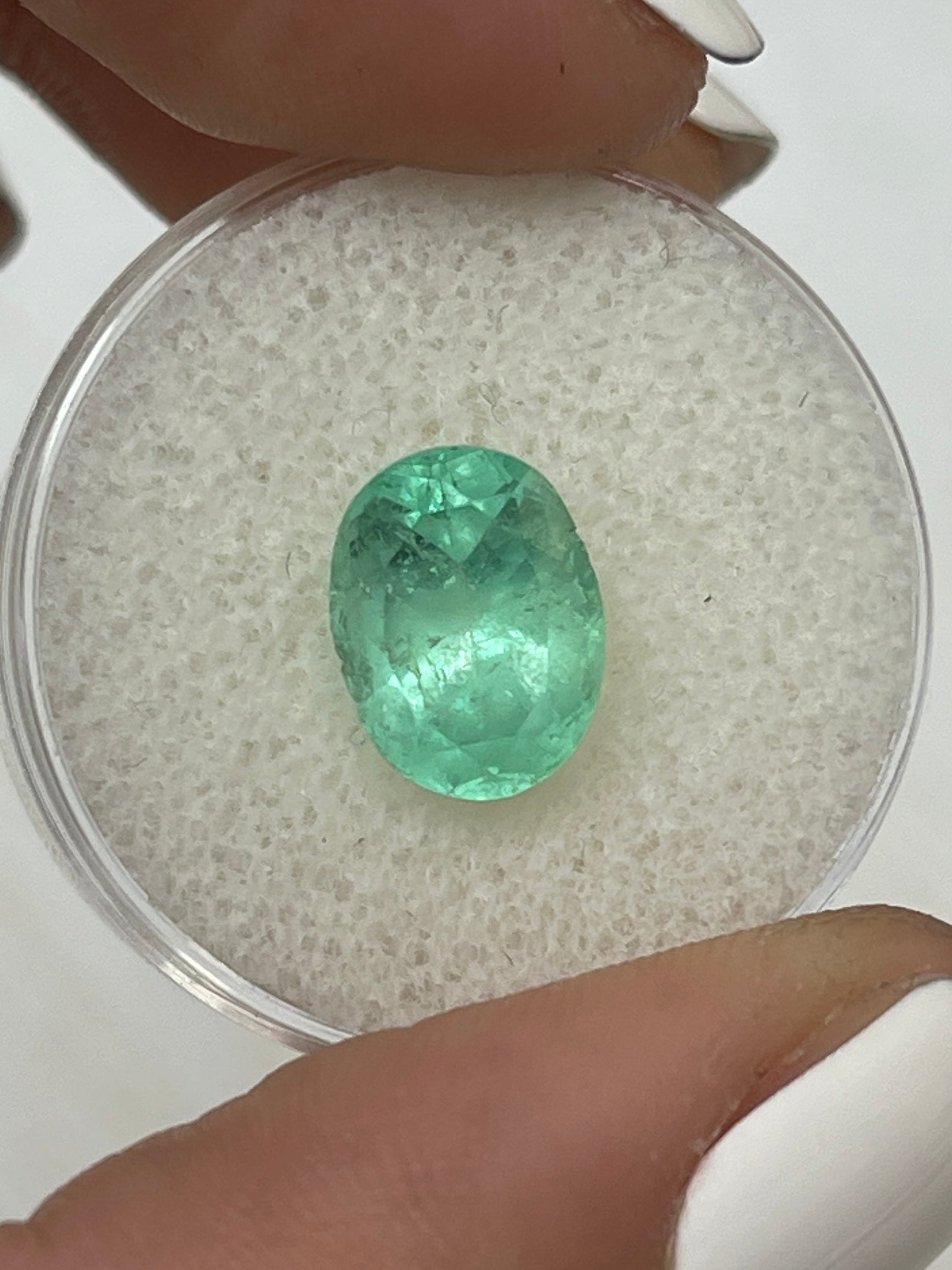 3.09 Carat pastel light green Colombian emerald loose oval cut by JR Colombian Emeralds. Natural gemstone with vibrant green hue.