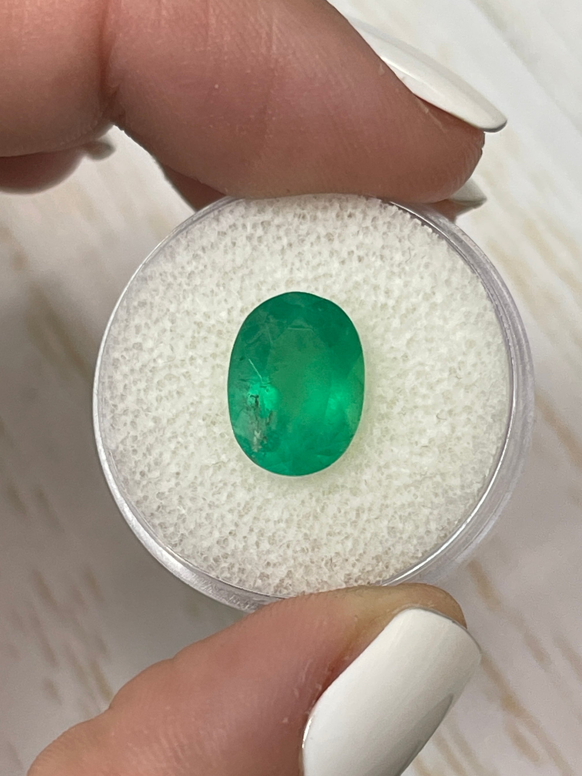 3.46 carat neon green natural Colombian emerald in oval cut, loose gemstone from JR Colombian Emeralds.