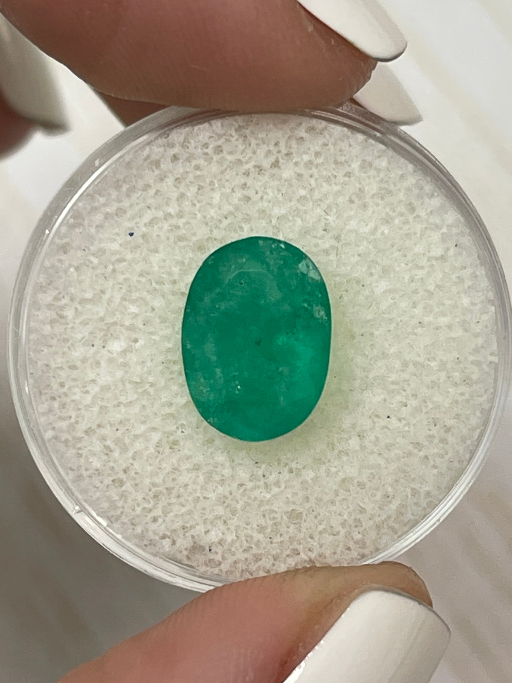 3.50 carat natural Colombian emerald loose oval cut with rich forest green color, showcased by JR Colombian Emeralds.