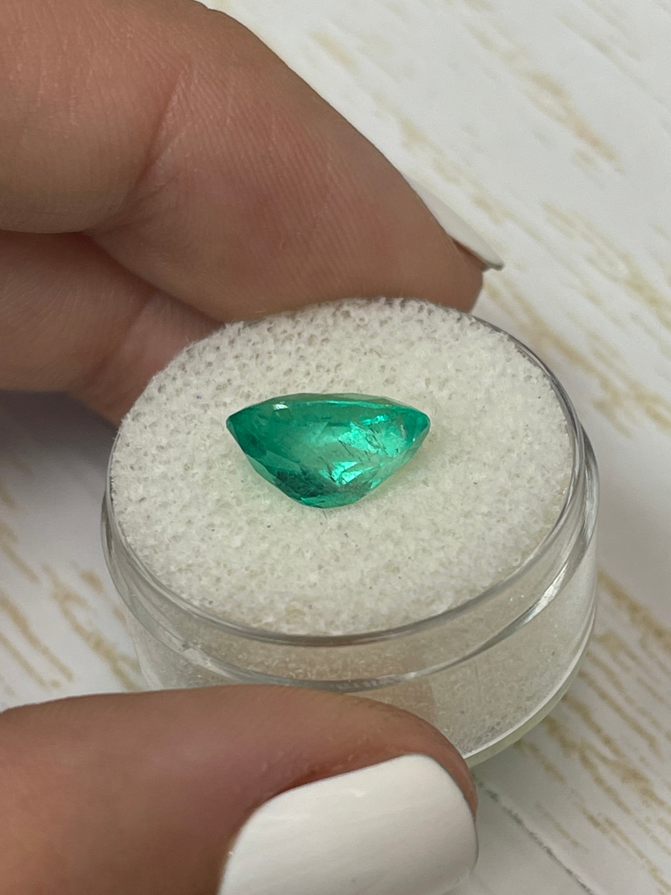 3.56 carat bi-color green natural Colombian emerald in oval cut, loose gemstone showcasing vibrant green hues.