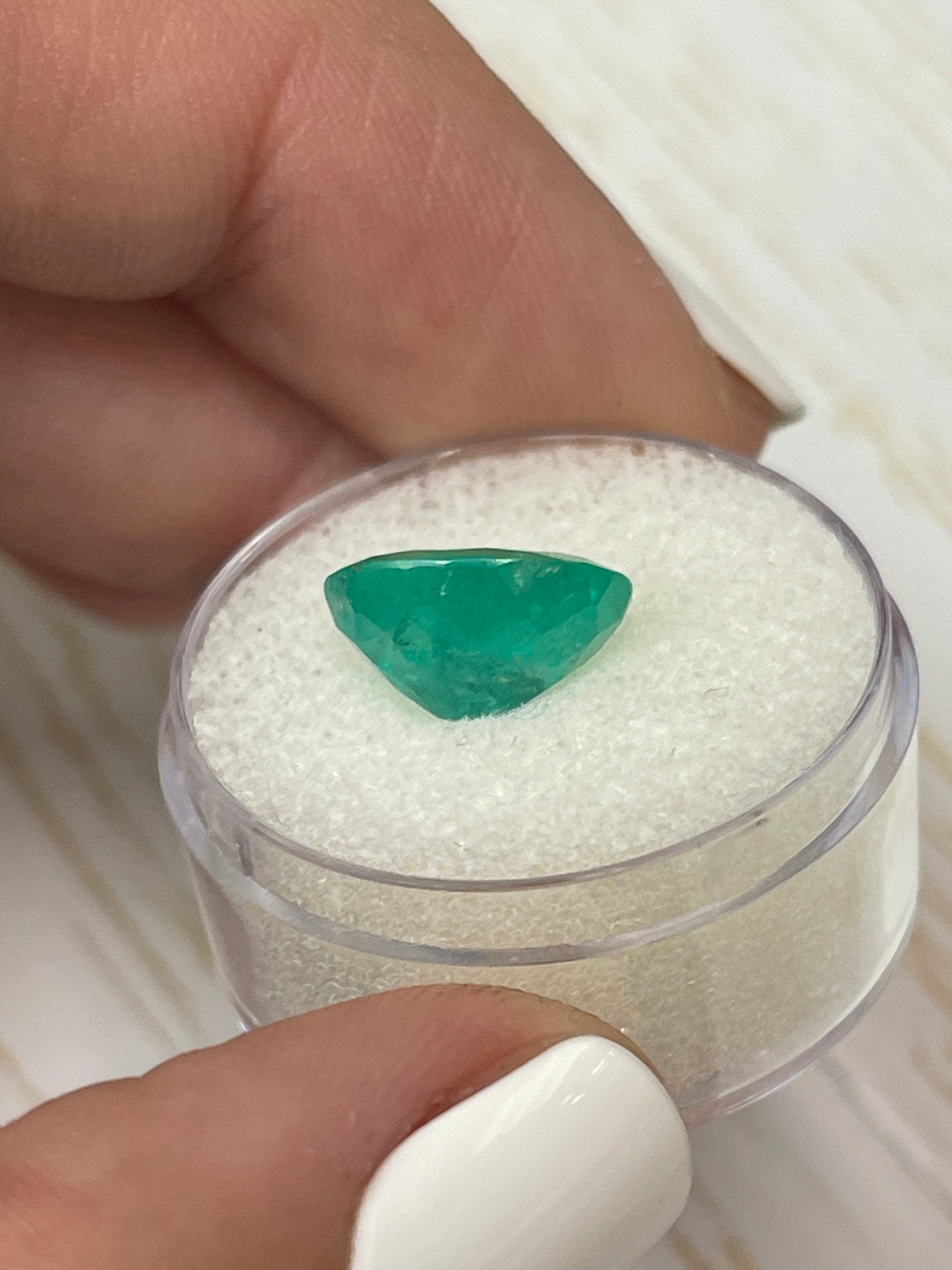 Natural 3.72 carat oval cut Colombian emerald from JR Colombian Emeralds, showcasing earthy green tones and a polished finish.