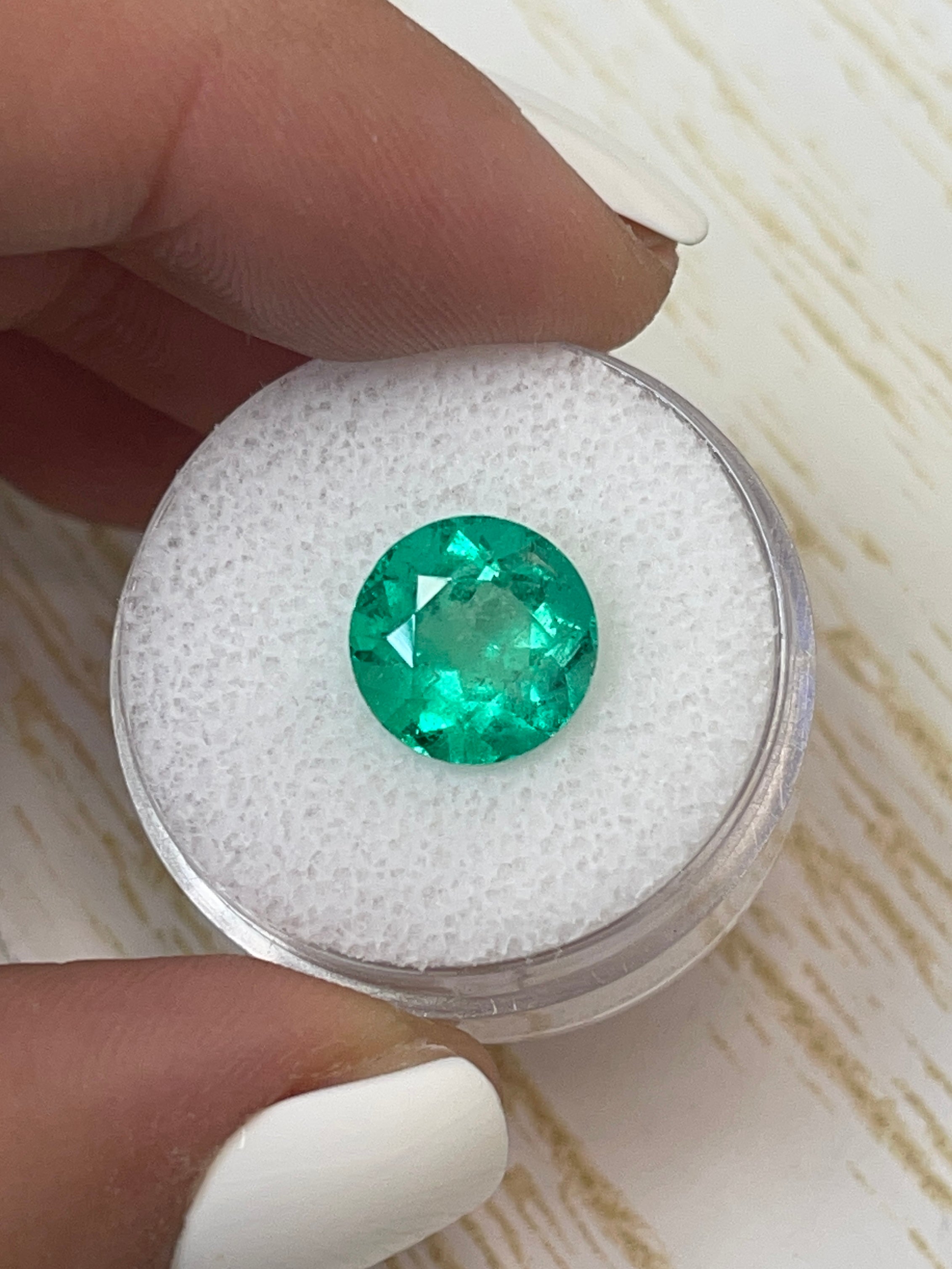 Vibrant green 3.79 carat natural round Colombian emerald loose gemstone with rich color and clarity.
