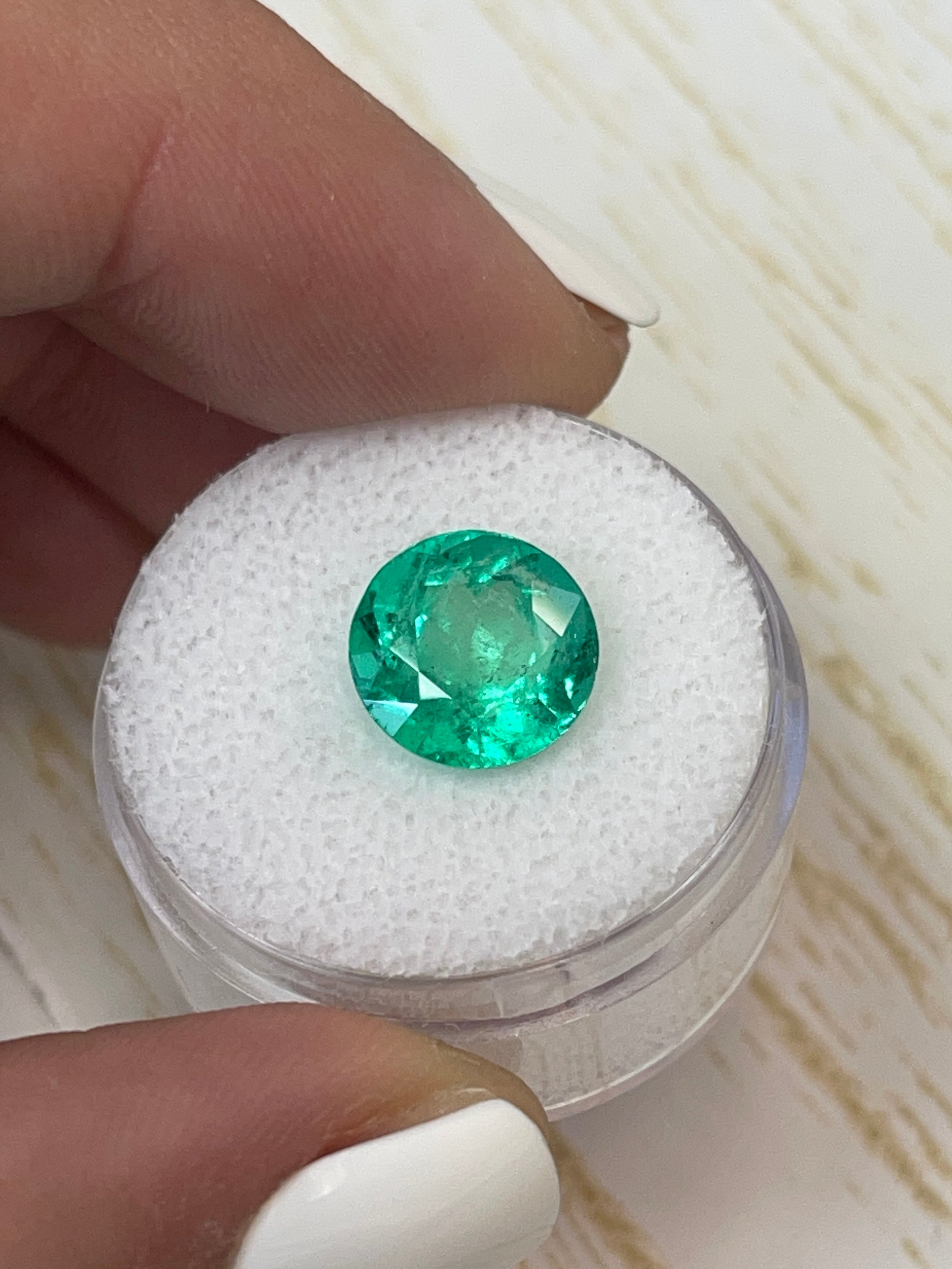 Vibrant 3.79 carat natural round Colombian emerald loose gemstone with bright green color and high clarity.