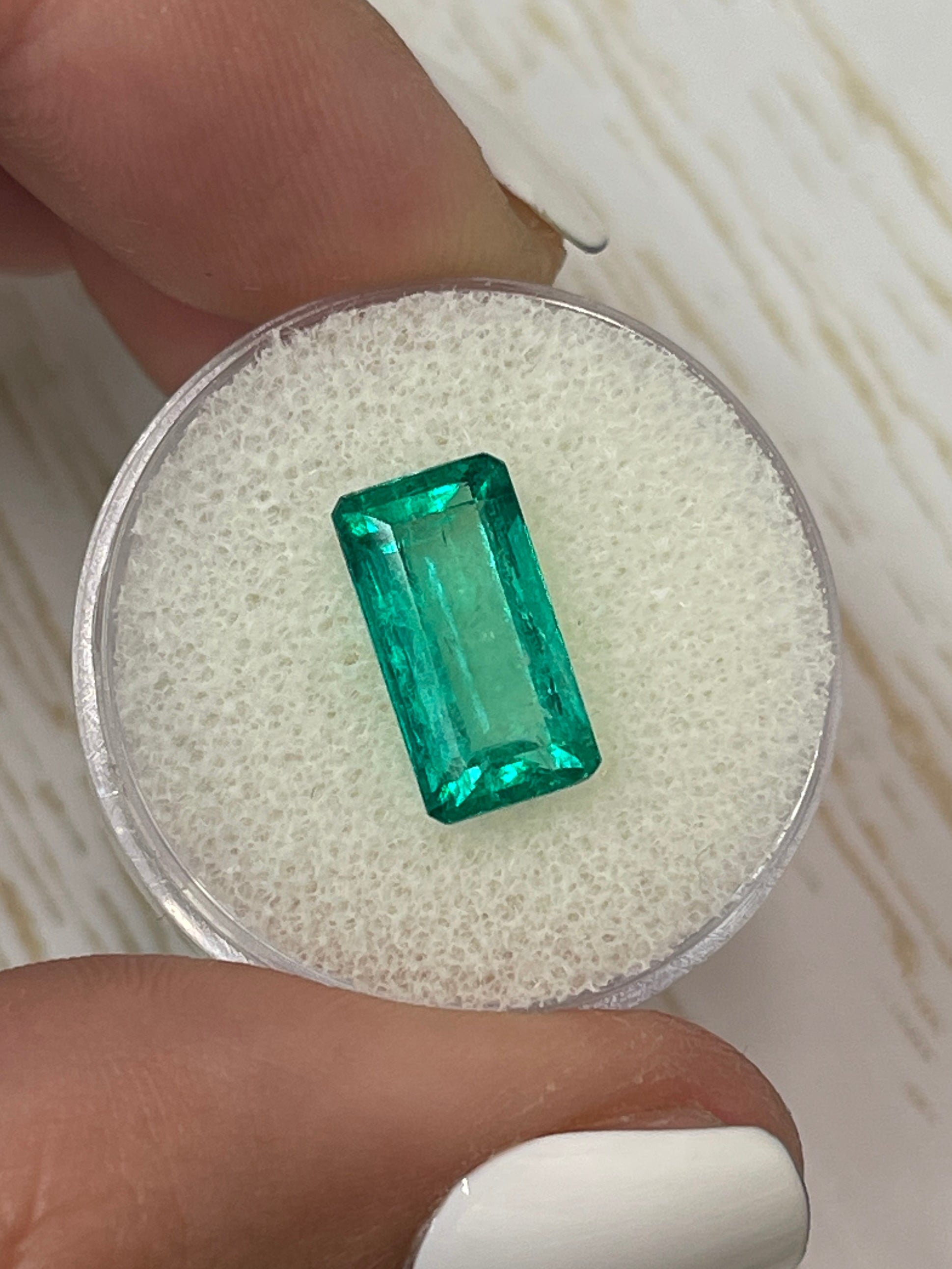 Vivid bluish-green 4.26 carat natural Colombian emerald loose gemstone in elongated emerald cut, from JR Colombian Emeralds.