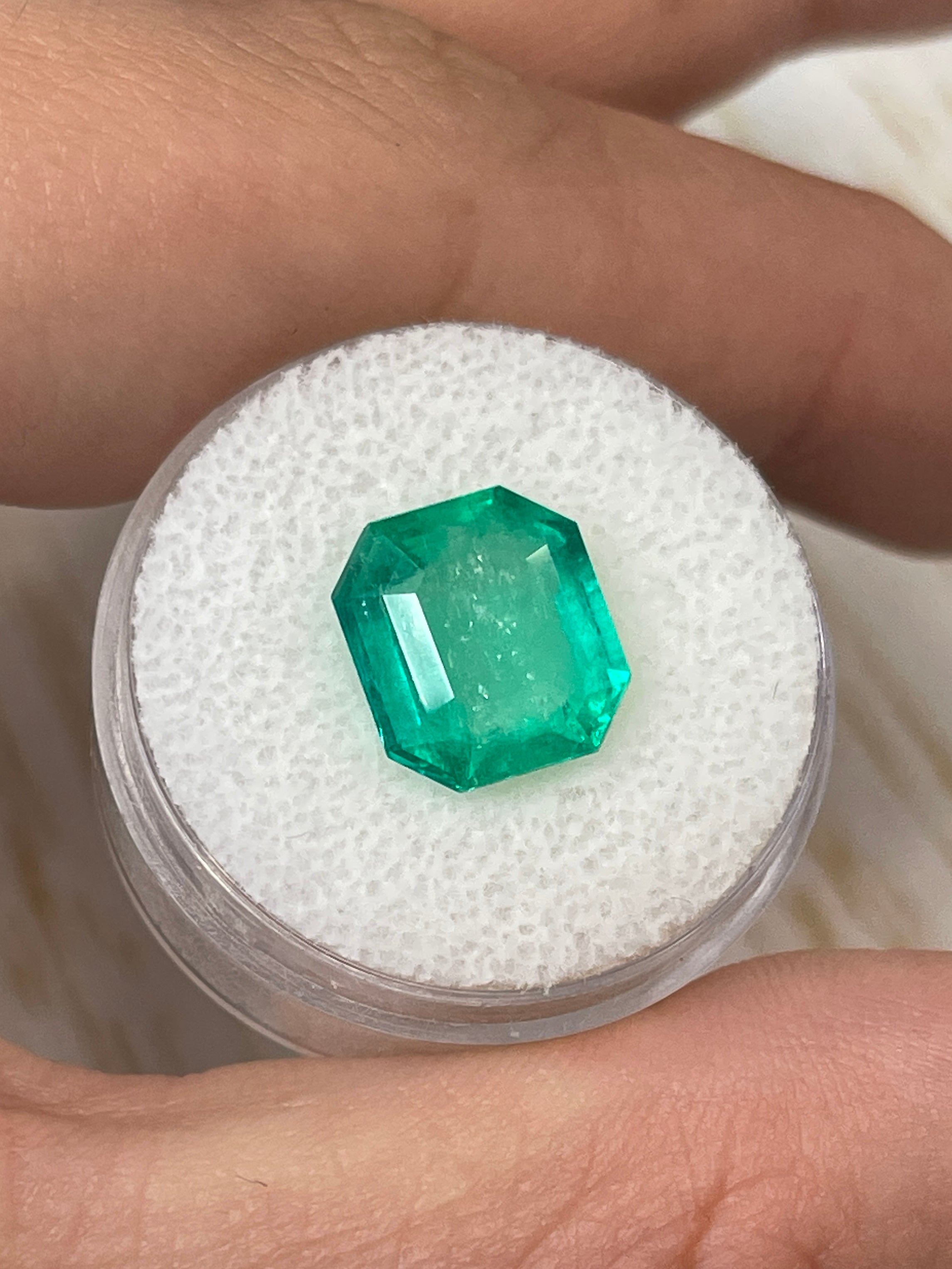 4.56 carat natural Colombian emerald loose gemstone in an emerald cut, showcasing its vibrant green color and clarity.