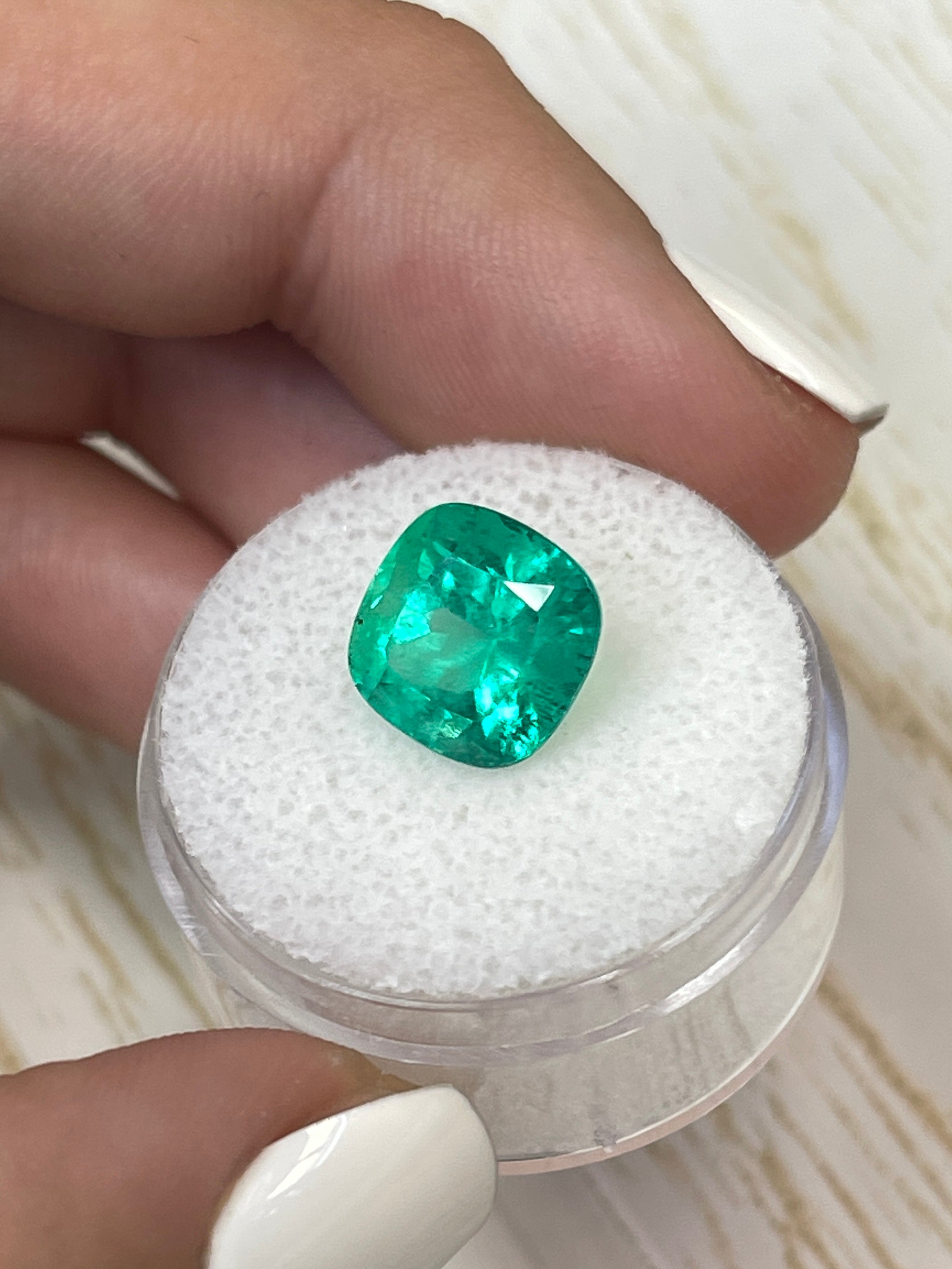 Bright green 4.72 carat Colombian emerald in cushion cut, showcasing natural brilliance and vibrant color.