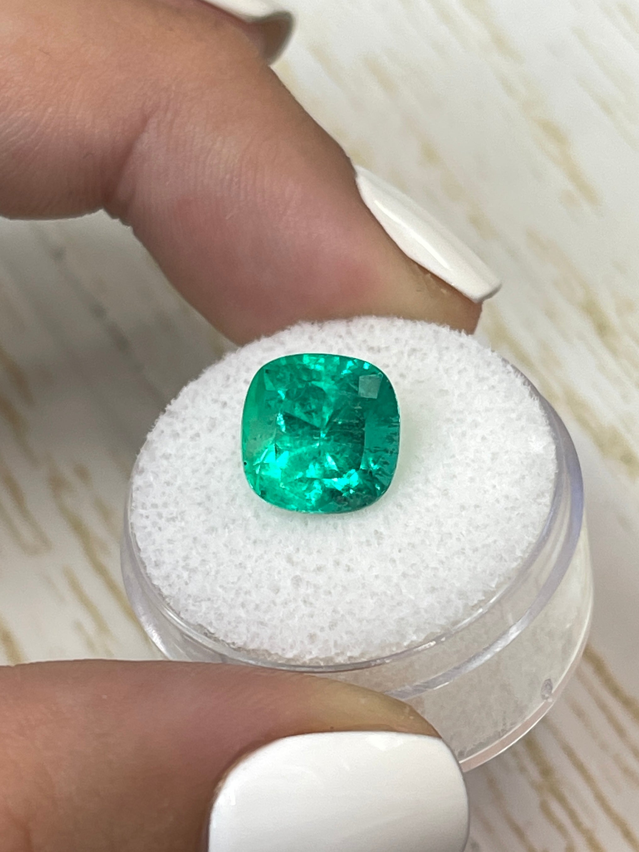 Bright green 4.72 carat Colombian emerald, cushion cut, showcasing natural clarity and vibrant color.