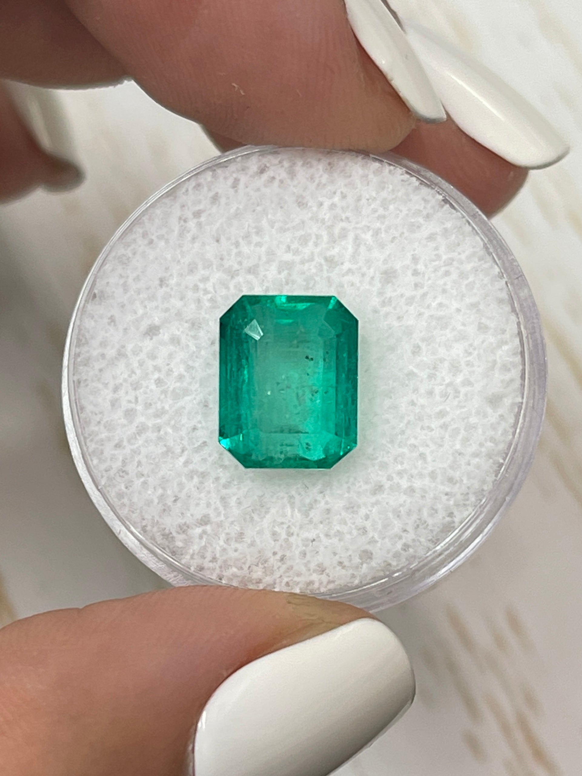 Natural 5.11 carat 10x8 green Colombian emerald loose gemstone in emerald cut by JR Colombian Emeralds.