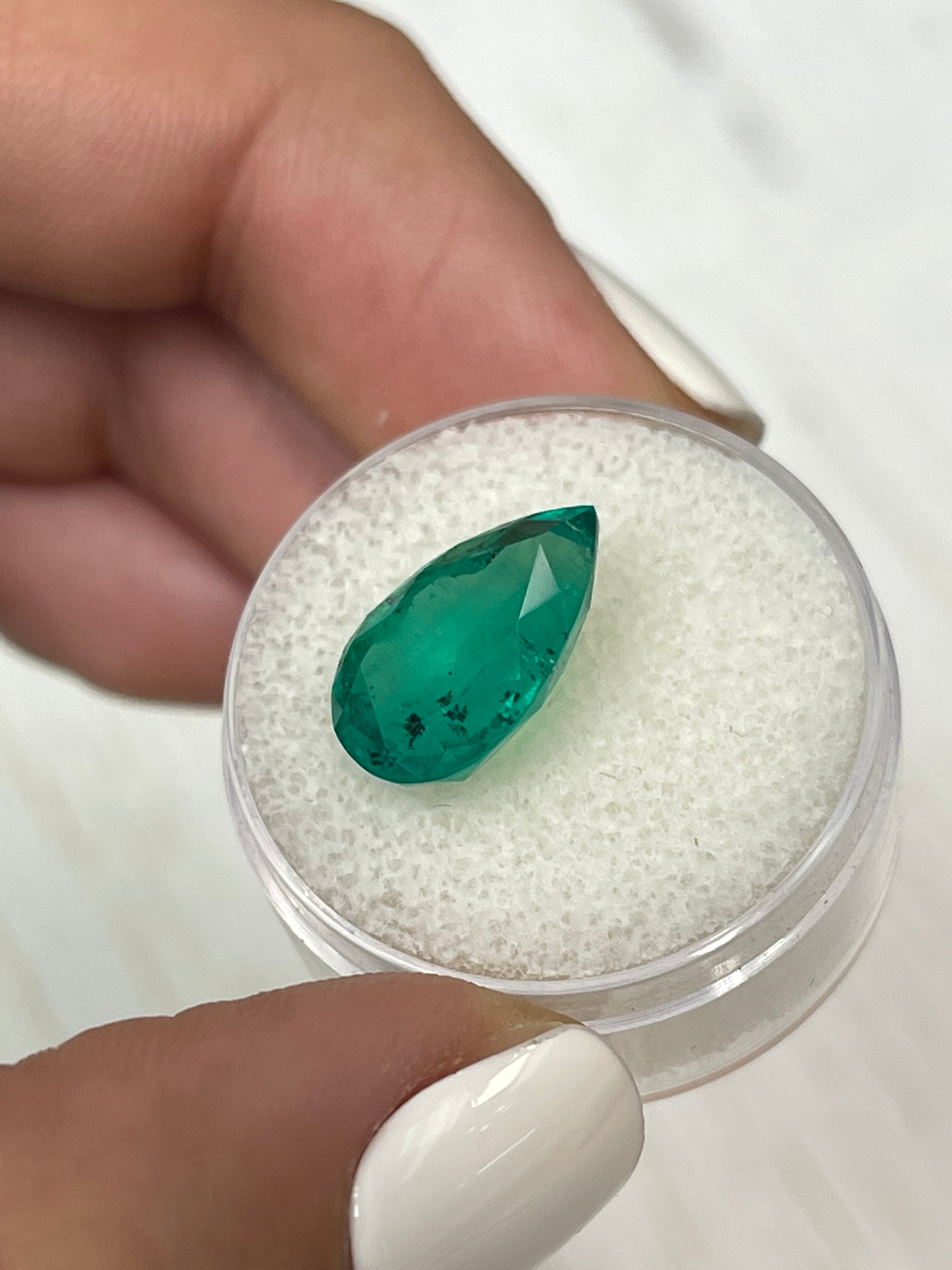 Natural 5.18 carat Colombian emerald loose gemstone with pear cut and freckled green color, from JR Colombian Emeralds.