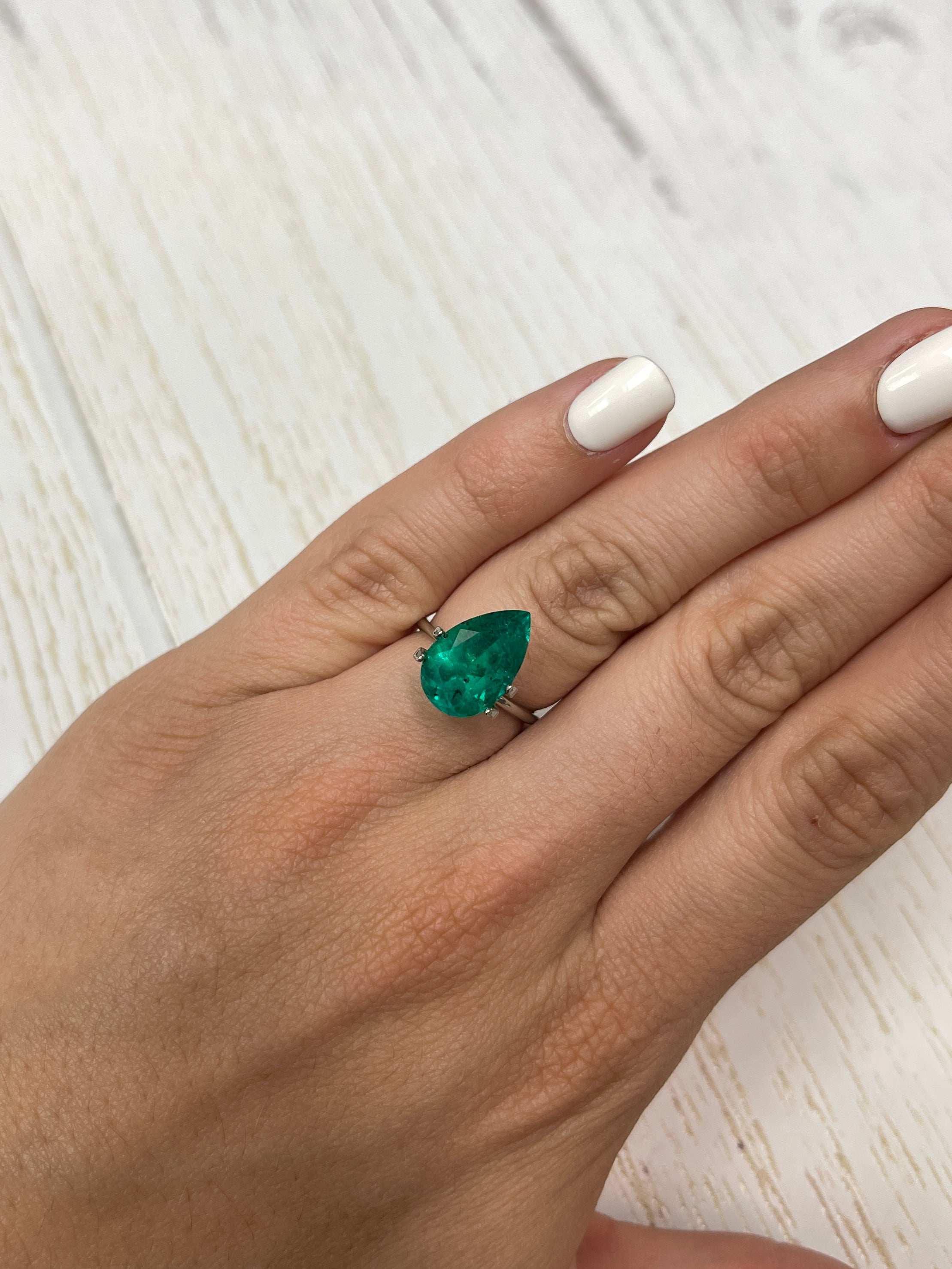 Natural 5.18 carat Colombian emerald loose with pear cut, featuring distinctive freckled green gemstone by JR Colombian Emeralds