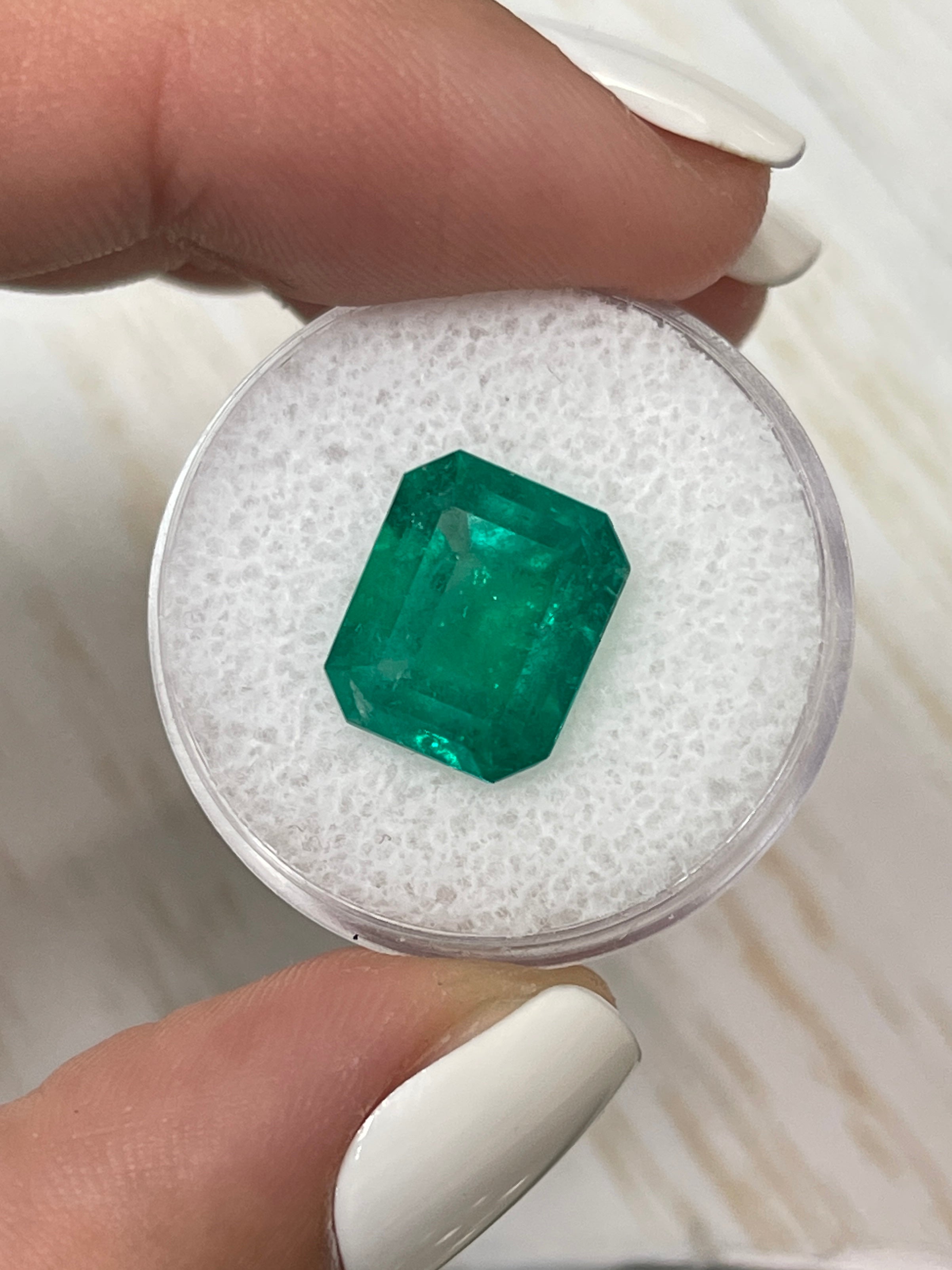 5.20 carat natural Colombian emerald loose gemstone in classic emerald cut, showcasing vibrant green color and fine quality.