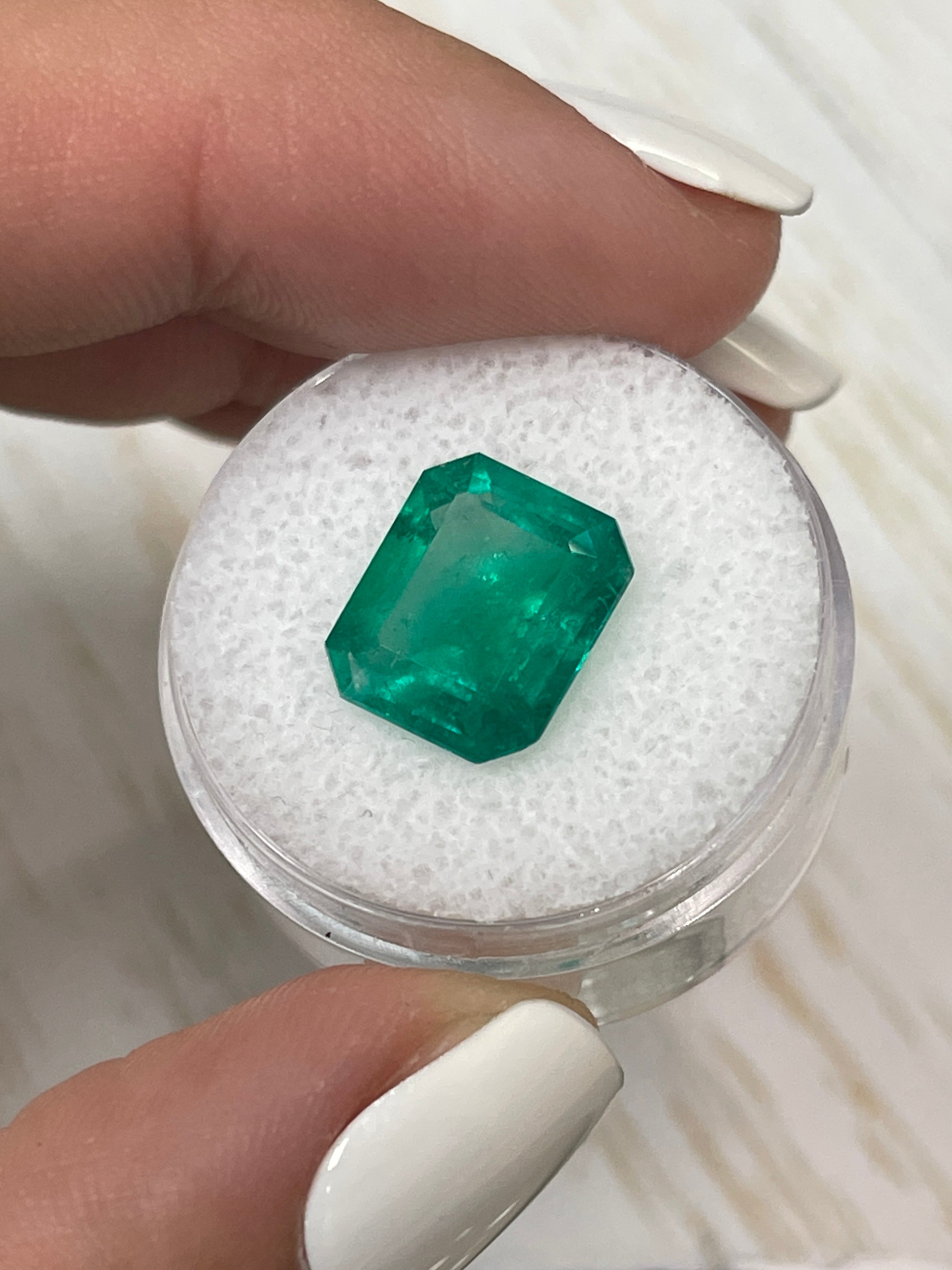 Fine 5.20 carat natural Colombian emerald loose gemstone in 12x10 mm classic emerald cut, high-quality and vibrant green color.